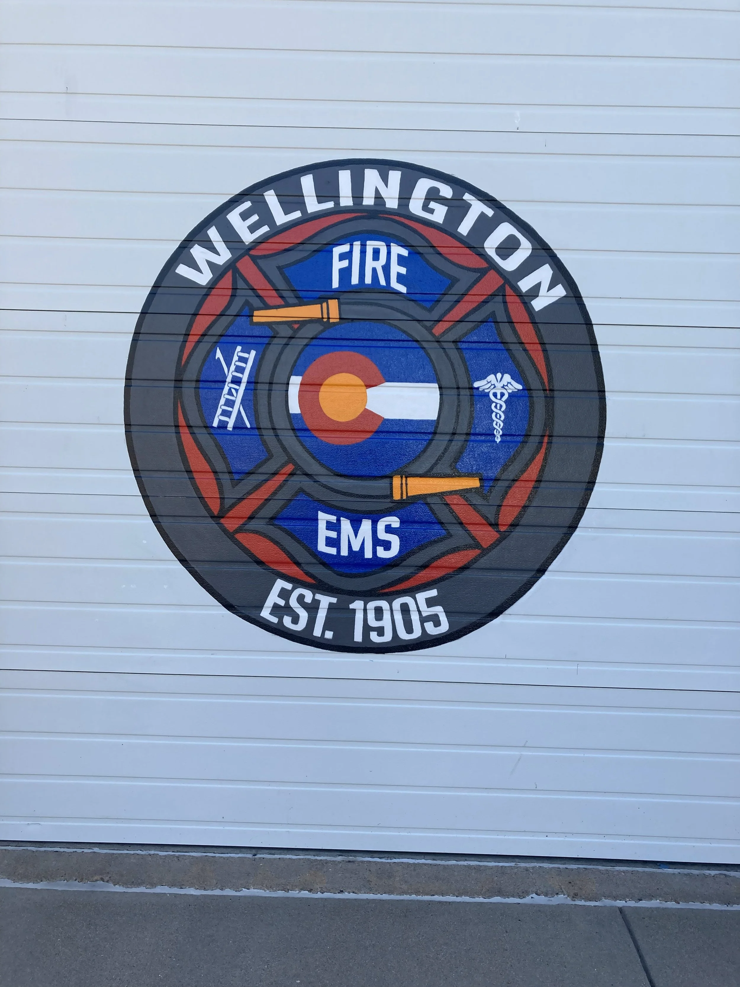 Detail of Wellington Fire Department, 2025, exterior acrylic paint on corrugated metal, 12' x 12' doors, commissioned by the City of Wellington