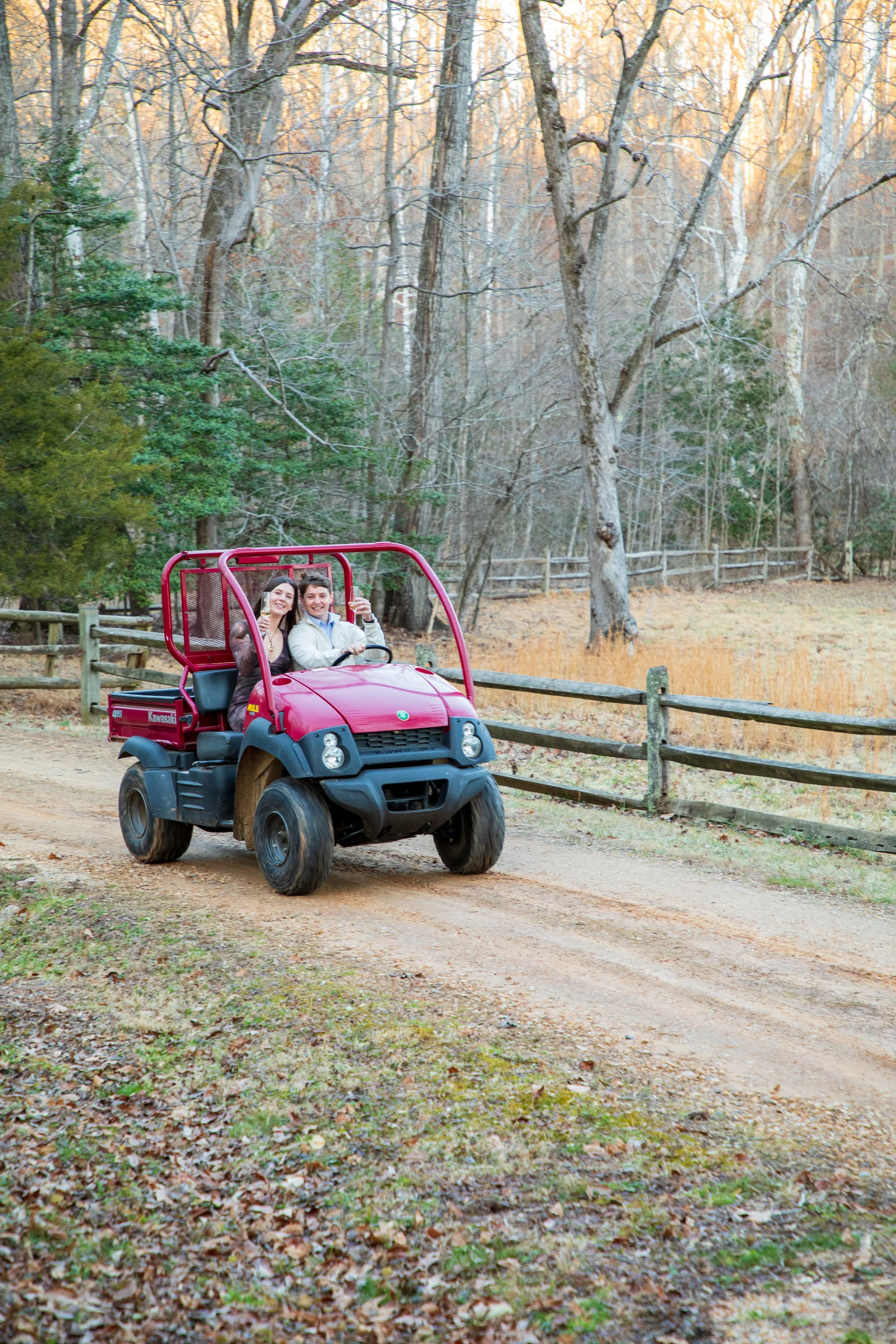 Engagement Photography by Will Locke near Richmond, VA in Montpelier. A newly engaged couple riding a red Kawasaki Mule utility vehicle.