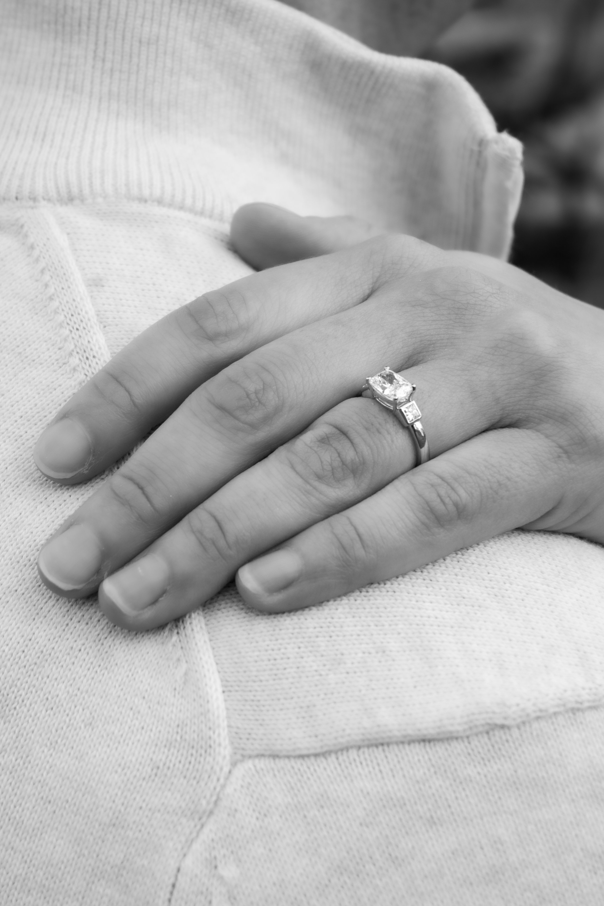 Engagement Photography by Will Locke near Richmond, VA in Montpelier. Close-up of a woman’s left hand resting on a man’s shoulder, showing an engagement ring with a large center stone and side stones.