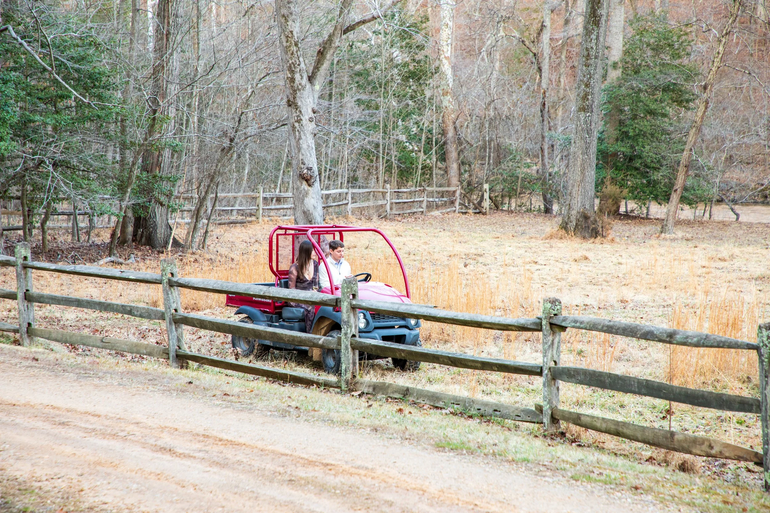 Engagement Photography by Will Locke near Richmond, VA in Montpelier. A newly engaged couple starts a red Kawasaki Mule utility vehicle.