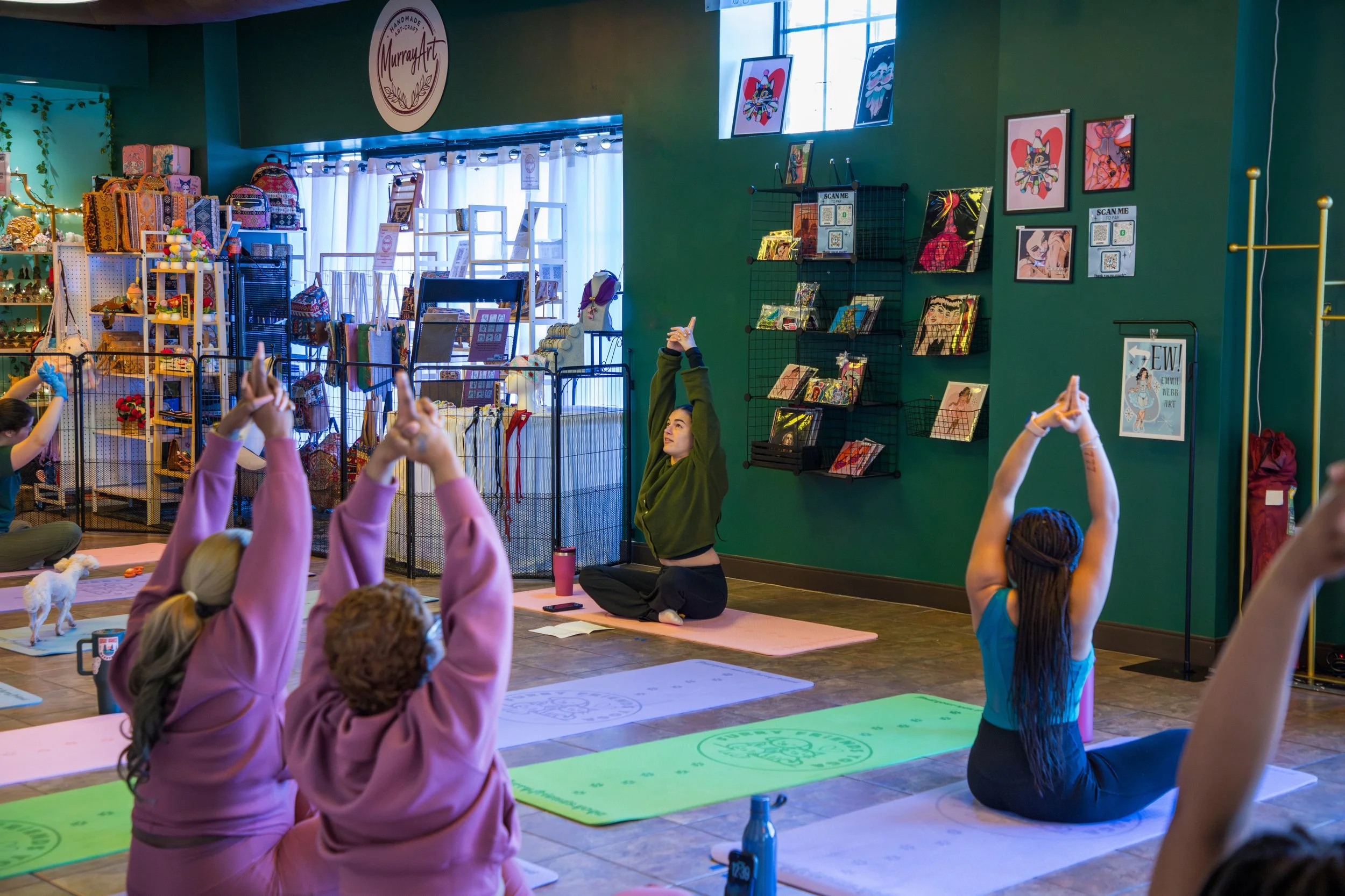 Group of people participating in a yoga or meditation class inside a colorful studio. Marketing and Event Photography by Will Locke. 