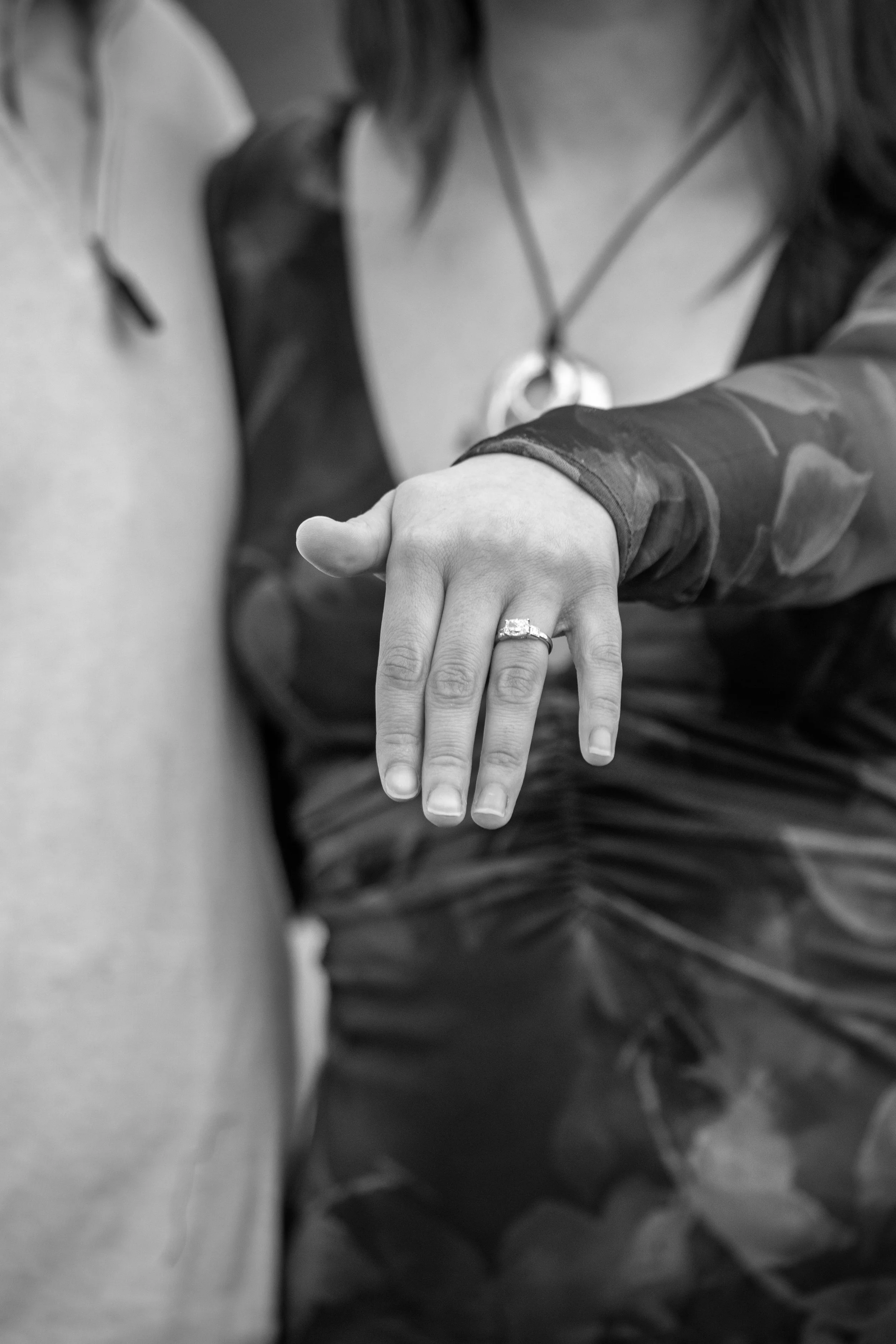 Engagement Photography by Will Locke near Richmond, VA in Montpelier. A black and white photo of a newly engaged couple pose and show off a engagement ring.