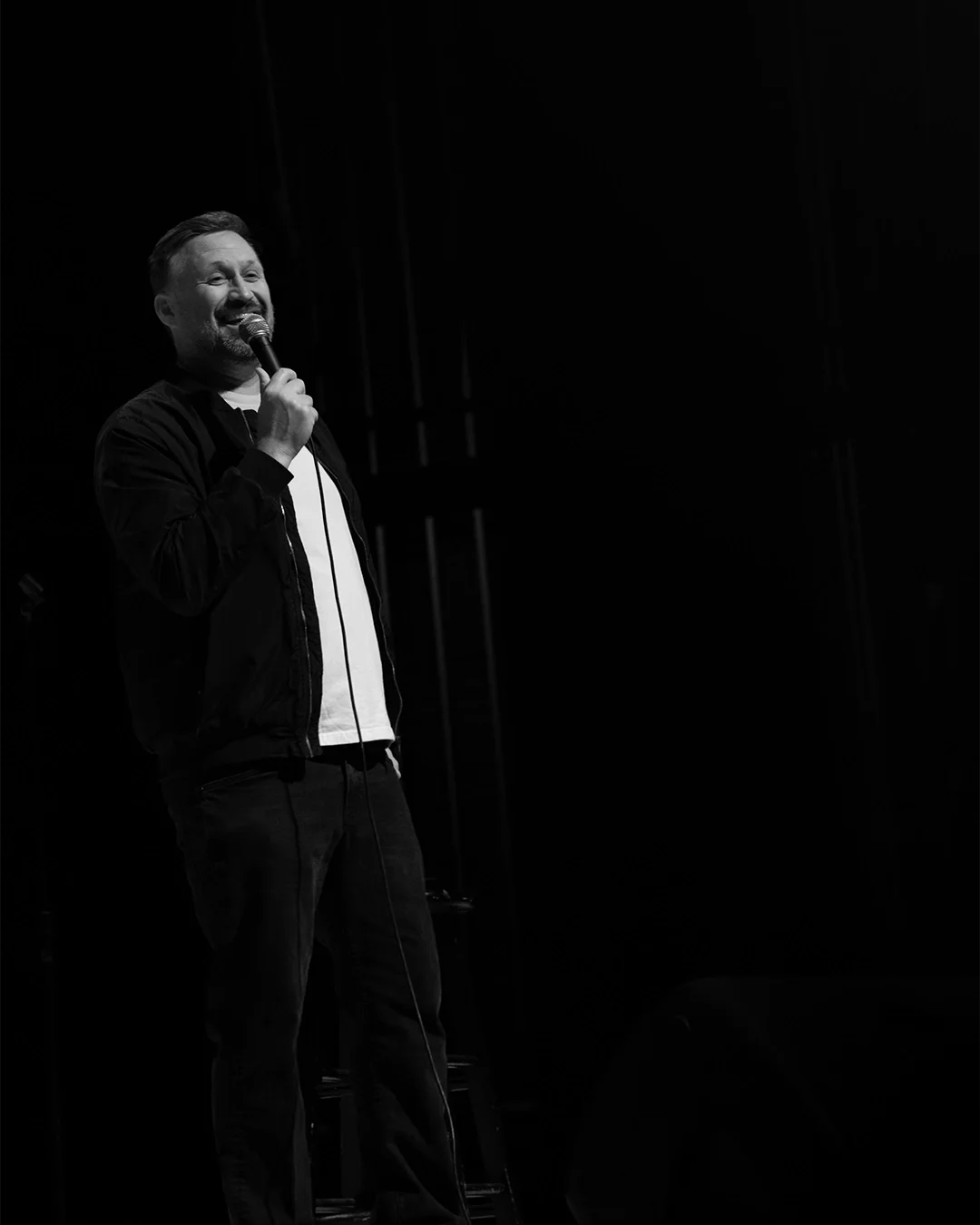 Josh Nelson Chuckling- B&W- Final.webp