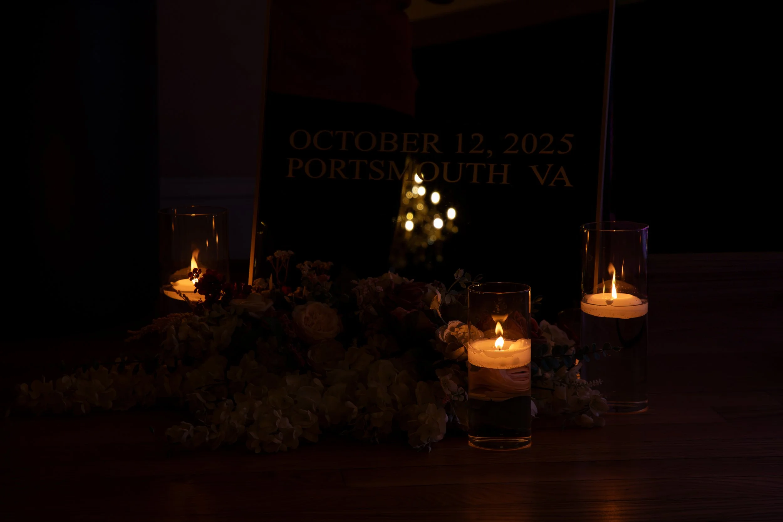 Wedding Photography by Will Locke. Memorial display with candles, flowers, and a plaque reading October 12, 2025, Portsmouth, VA.