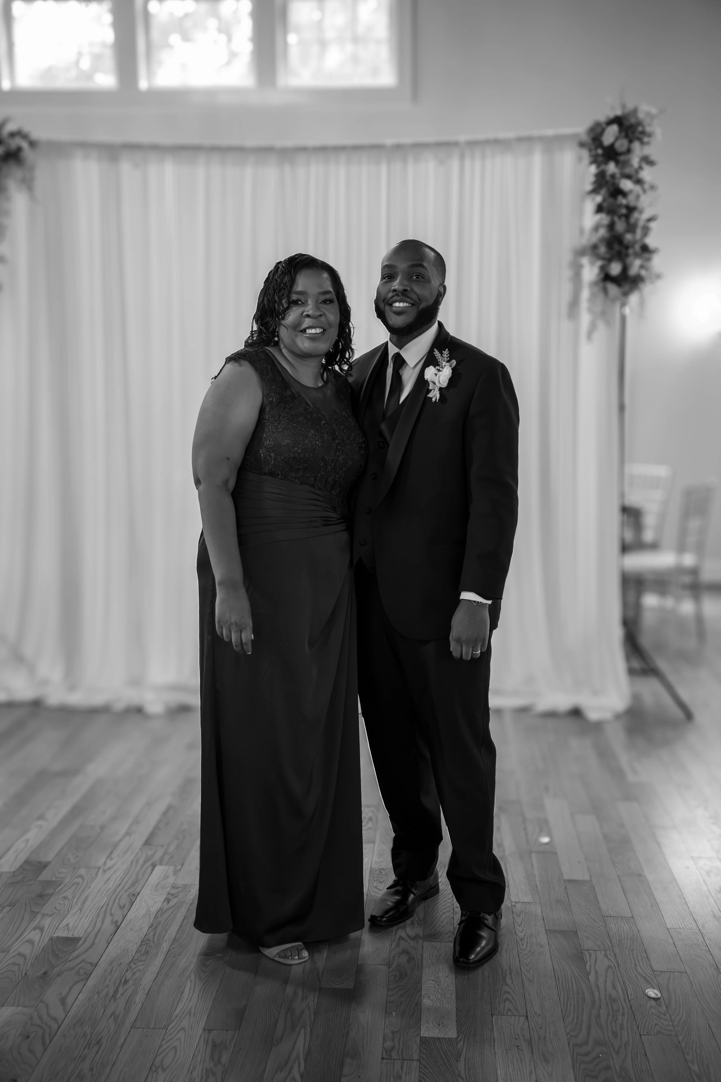 Photo & Video by Will Locke Wedding Photography at the Woman's Club of Portsmouth in Virginia. A smiling woman in a long formal gown and a smiling man in a suit with boutonniere.