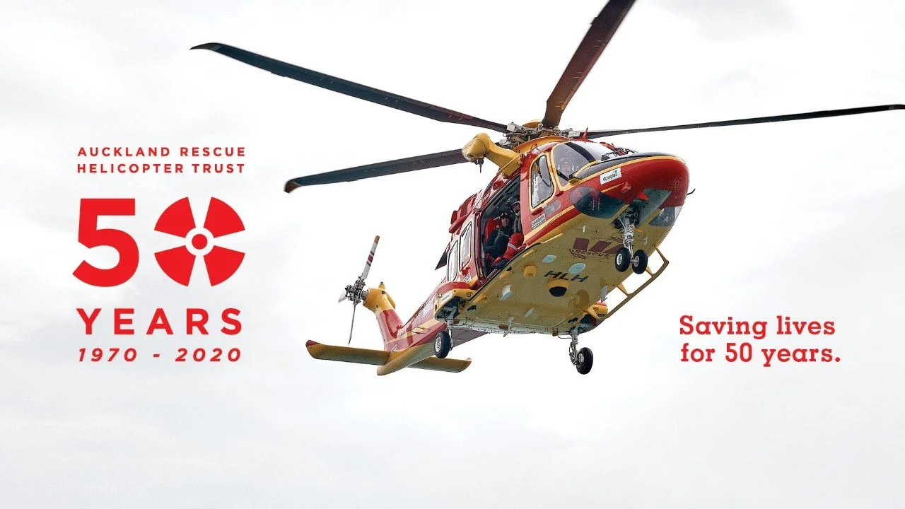 50th Anniversary image of Auckland Rescue Helicopter Trust showing one of the helicopters in the air.