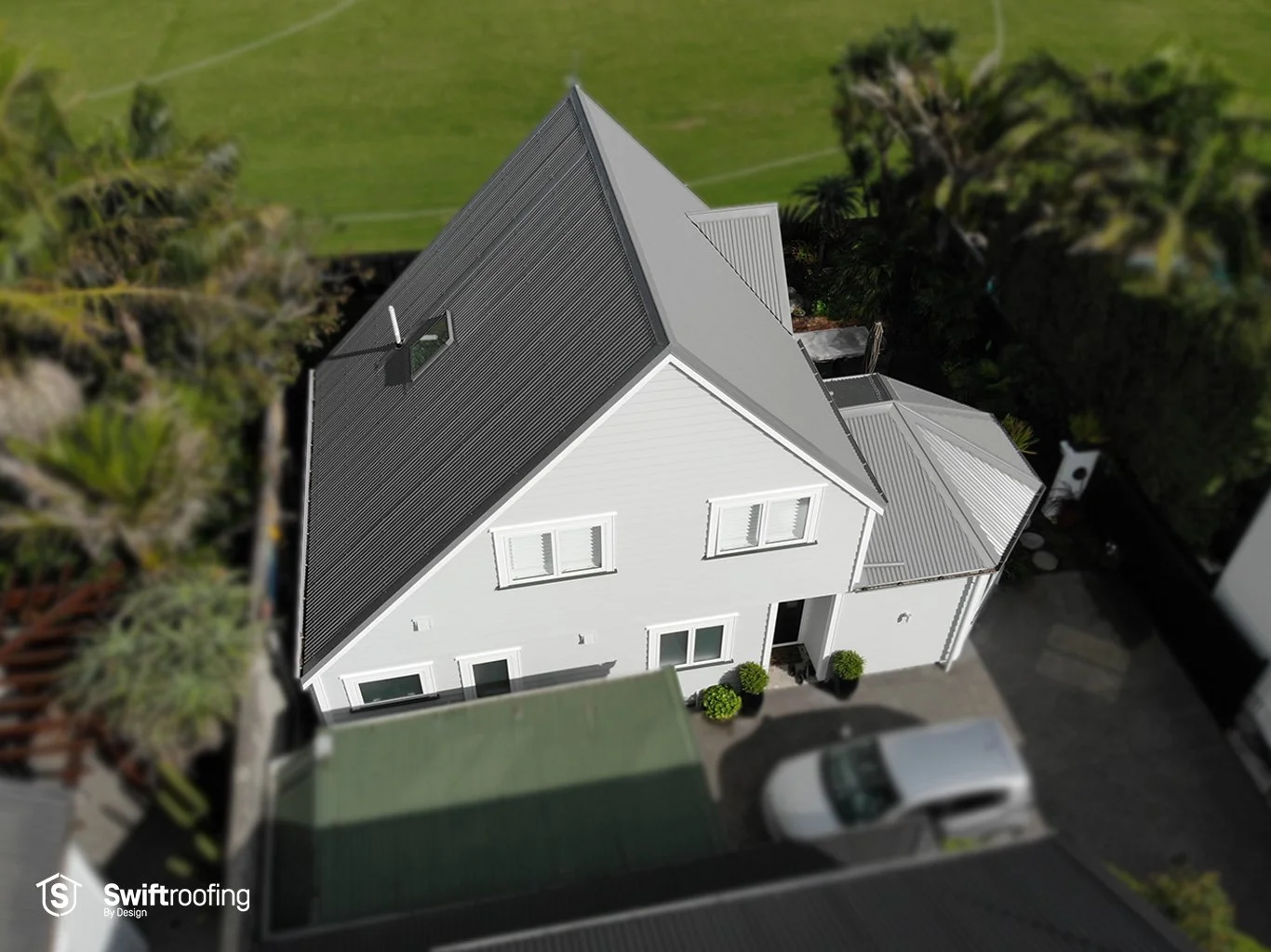 Drone view down onto front of new Swift Roofing installed Corrugate Gull Grey roof in Ponsonby for Licensed Reclads.