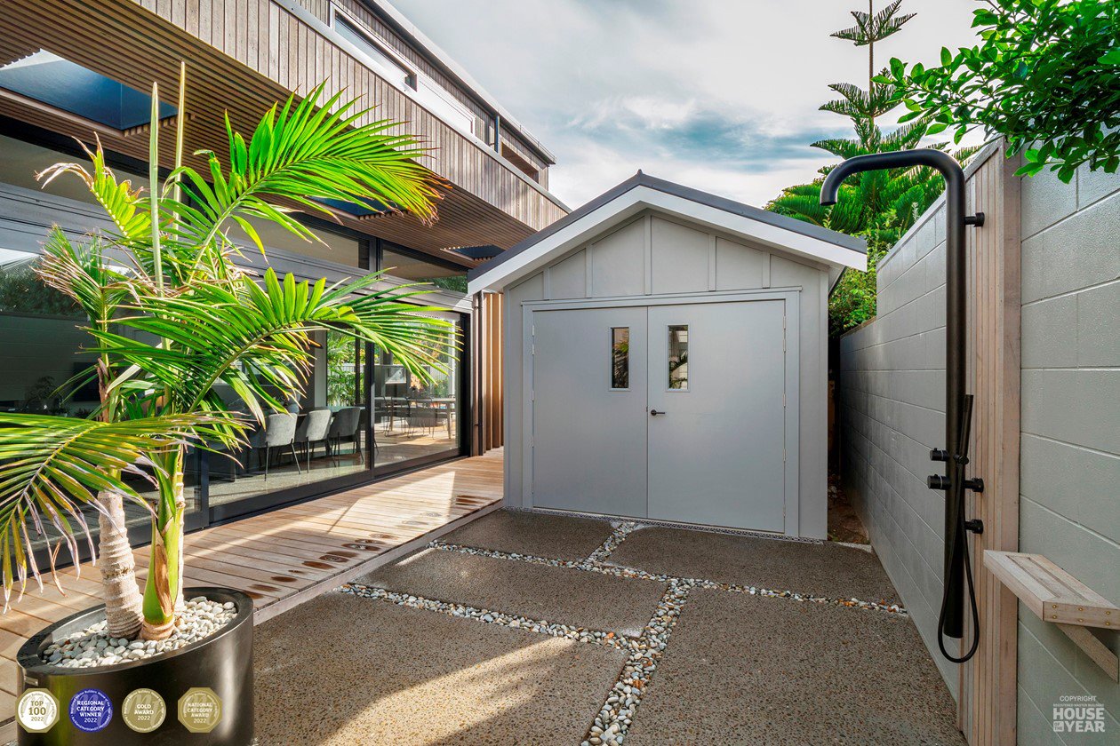 Image c/o House of the Year - View down driveway to garage at Devonport project where Swift Roofing installed Colorsteel Maxx Grey Friars coloured roofs to the existing house, the new addition and the minor dwelling. Broswick Builders won a National