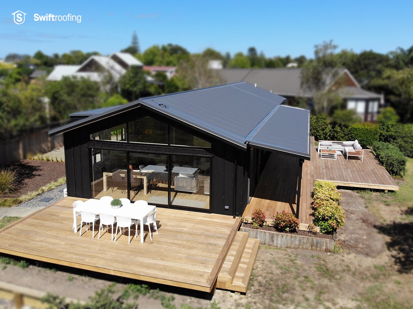 Drone view down onto back yard and deck of Odge renovation where Swift Roofing installed Corrugate, True Oak and Corrugate Laserlite to the roof areas, along with Marley Typhoon Spouting and PVC downpipes.