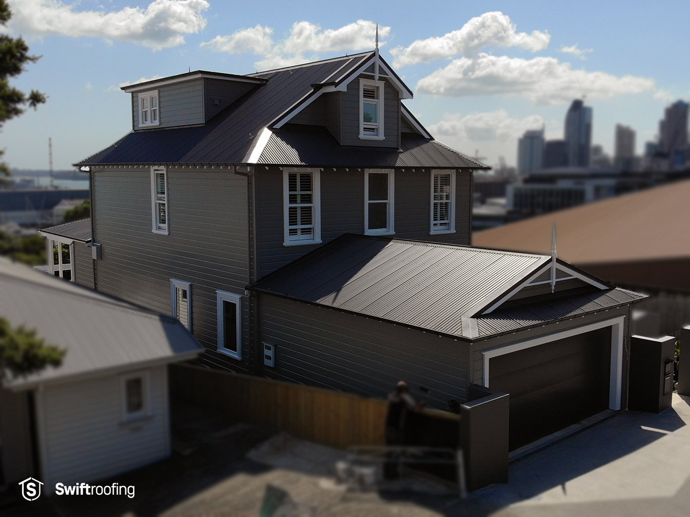 Drone view from road of garage and main roofs on St Mary's Bay Craft Renovation where Swift Roofing installed new Corrugate profiled roofing to roof areas.
