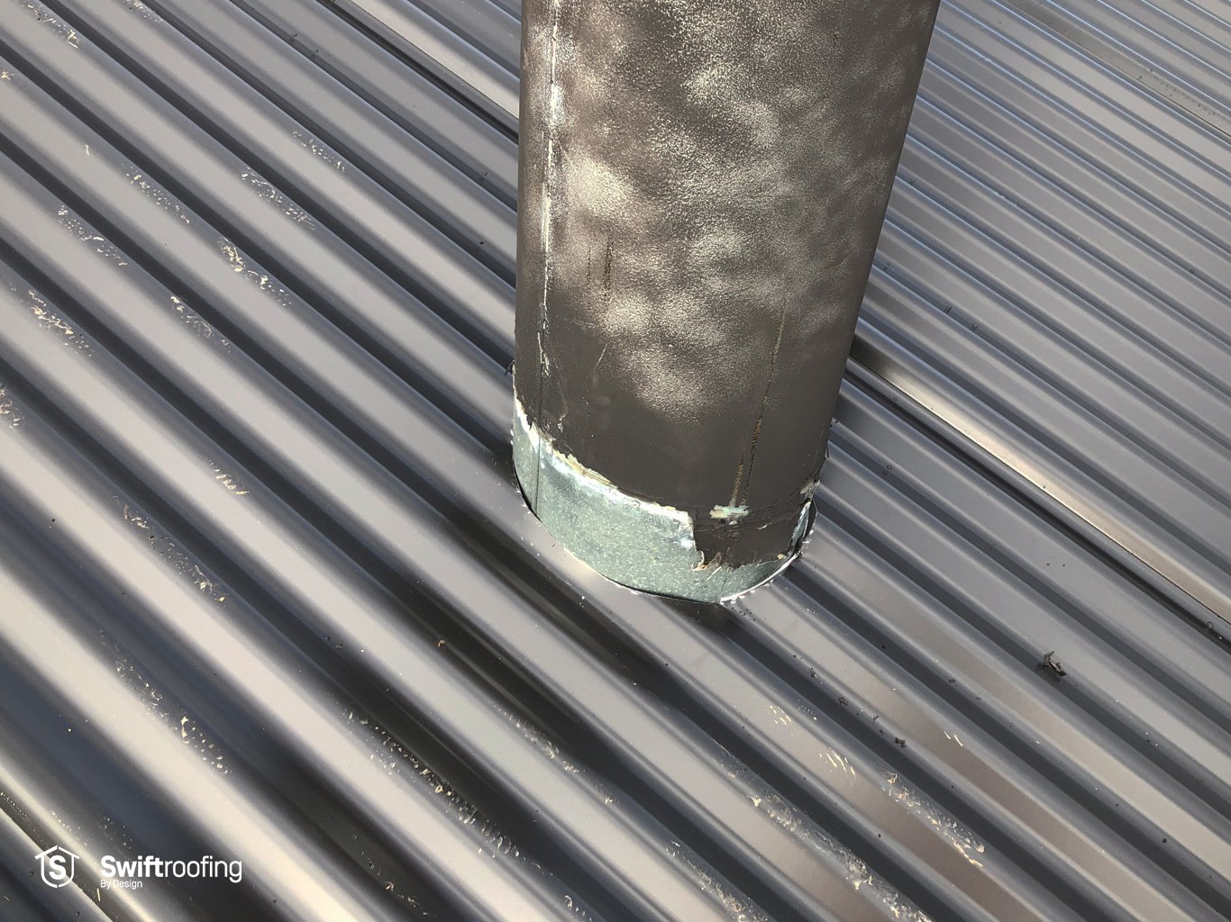 Photo of chimney penetration ahead of cowl and EPDM installation to seal from weather on double strip roof replacement where Swift Roofing installed the new Corrugate & Trimrib roofs in Torbay.