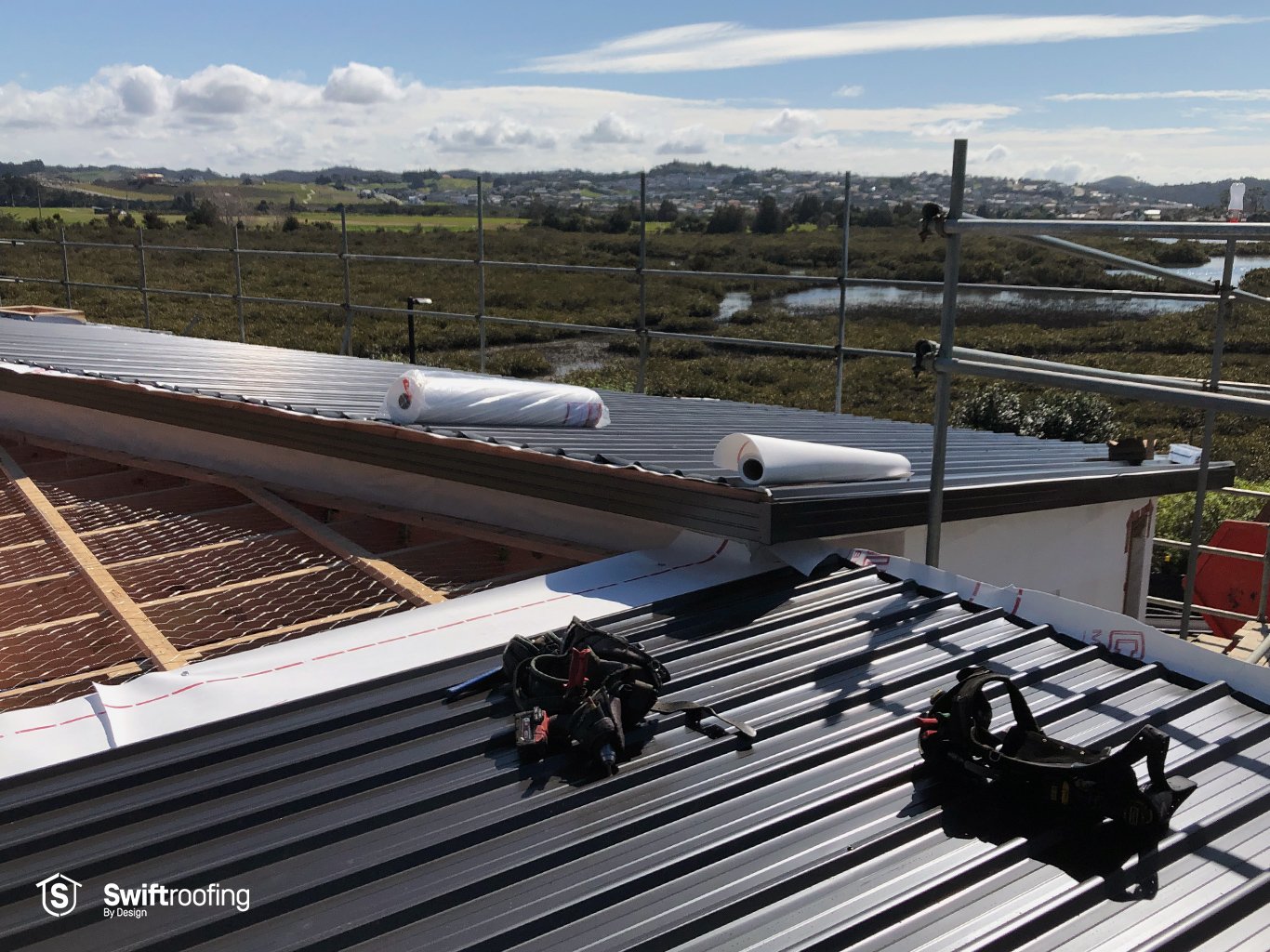 Swift Roofing installer work belts on Silver Medal House of the Year Winner where Swift Roofing installed Colorsteel Maxx coated, Flaxpod coloured Trimrib profile roofing.
