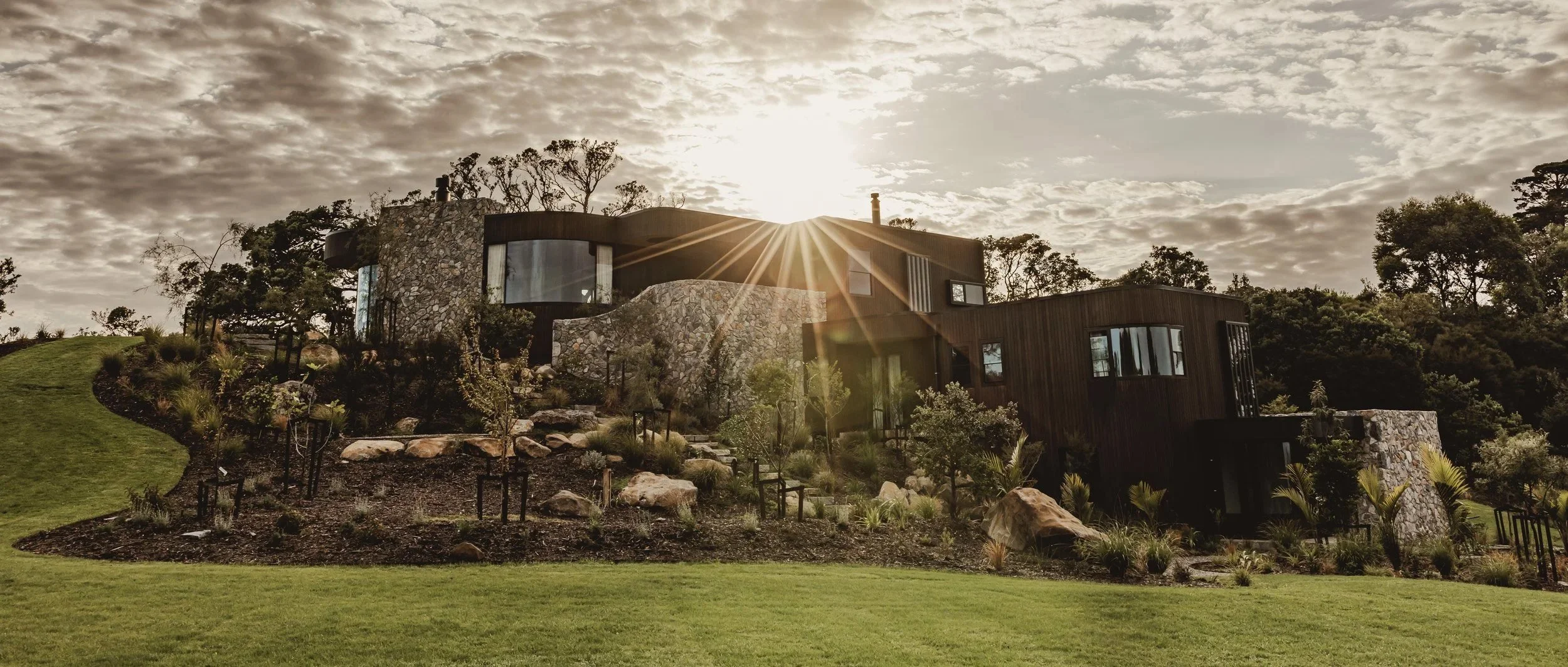 Sunrise over Ti Point House, a Lindesay / Construction Crosson Architects / Rochford Landscapes project where Swift Roofing installed RT7 Roof in ColorCote Horoeka coloured MagnaFlow from Roofing Industries. Kate Little Photo