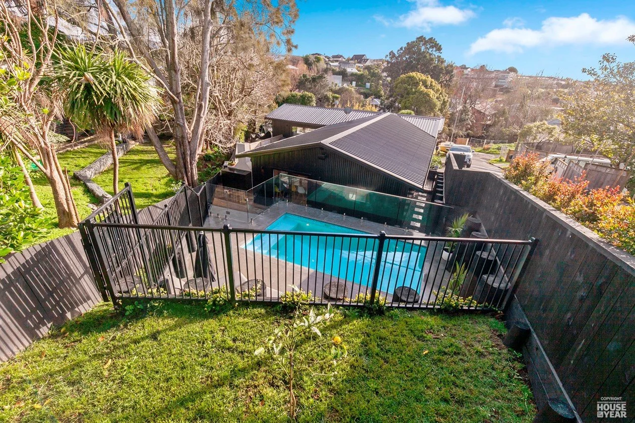View down over pool towards Swift Roofing installed Trimrib Profile Roof & Dimondclad Rib50 Wall Cladding on House of the Year Builders Own Home entry in Rothesay Bay - Image c/o House of the Year