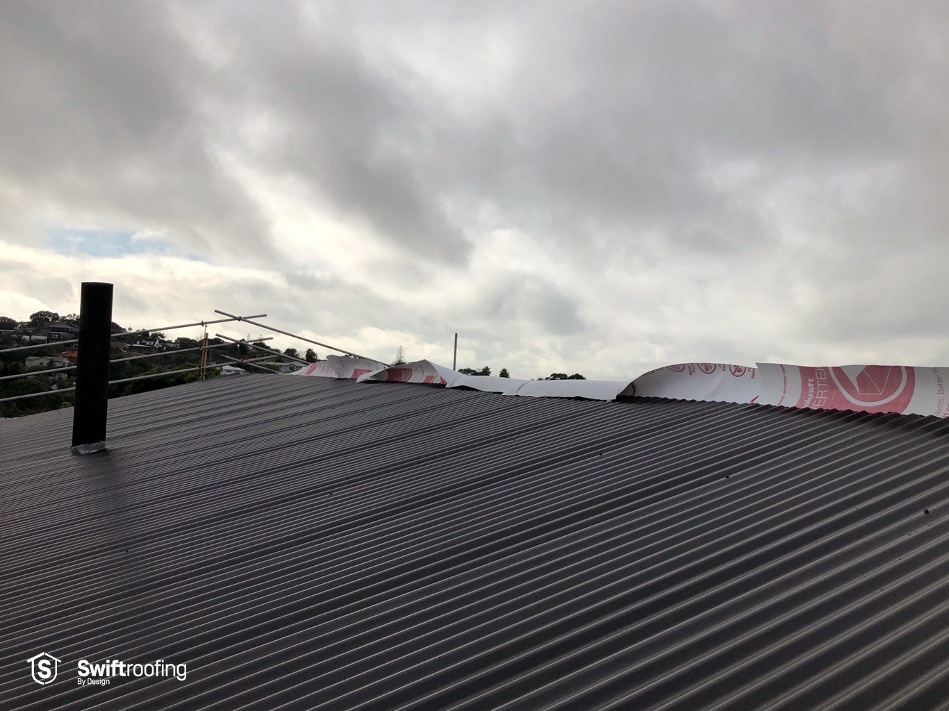Photo of one side of new Corrugate roof laid on double strip roof replacement where Swift Roofing installed the new Corrugate & Trimrib roofs in Torbay.