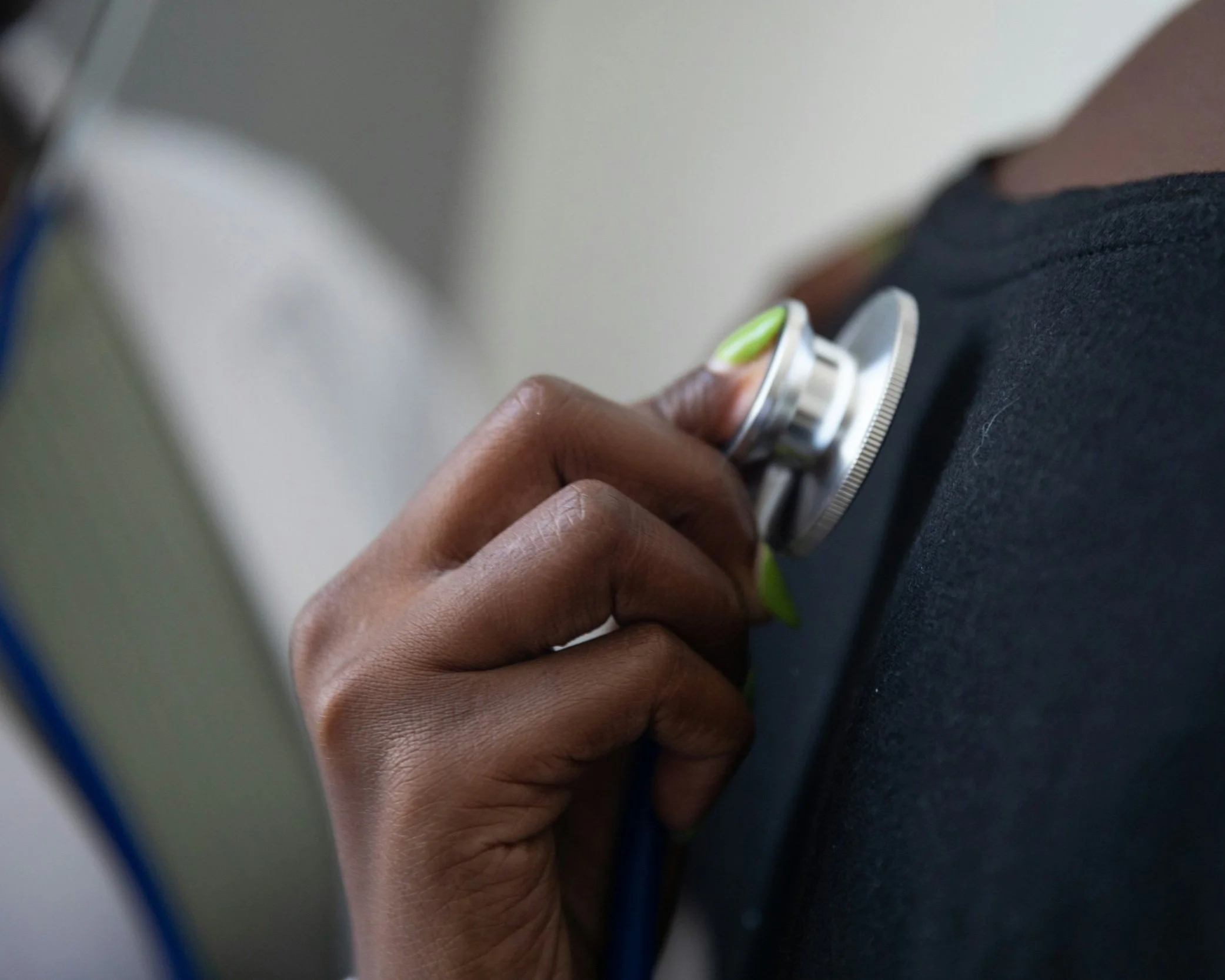 Doctor using stethoscope on medical patient