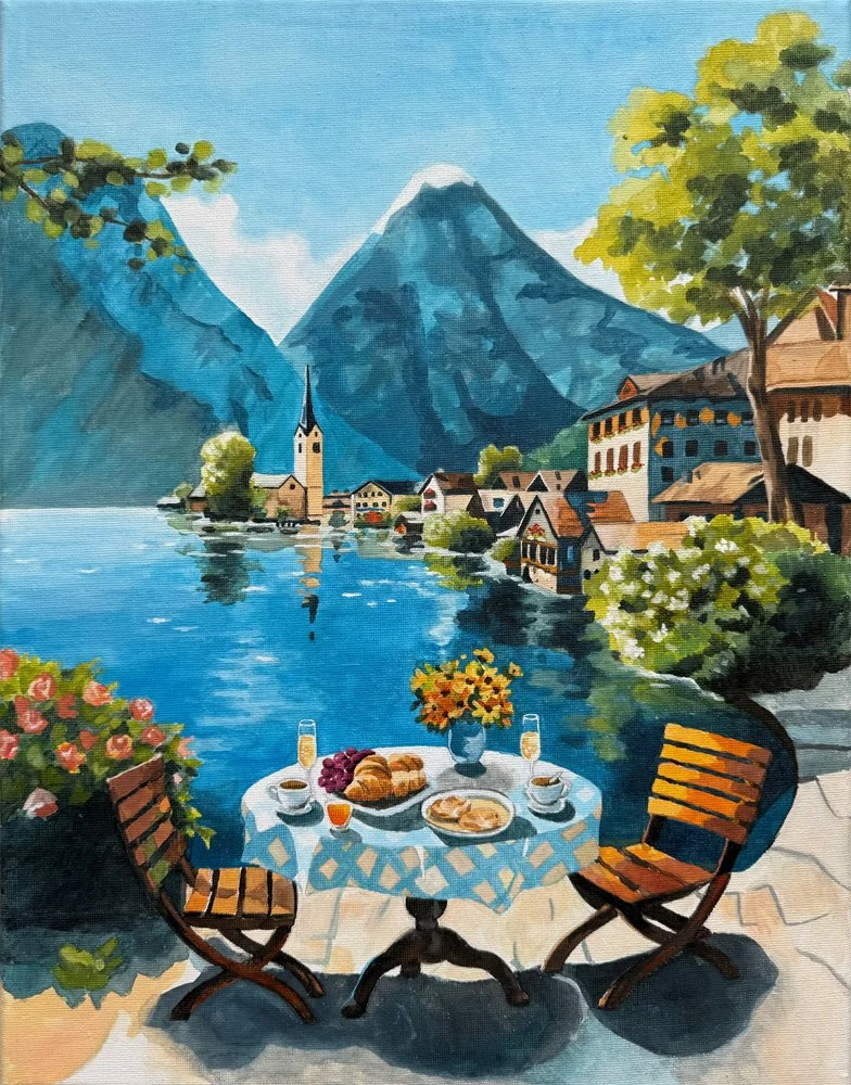 A painting of a lake scene with mountains in the background. There is a small village with houses and a church with a tall steeple. In the foreground, there is a table with a blue and white tablecloth, set with breakfast items, and two wooden chairs.