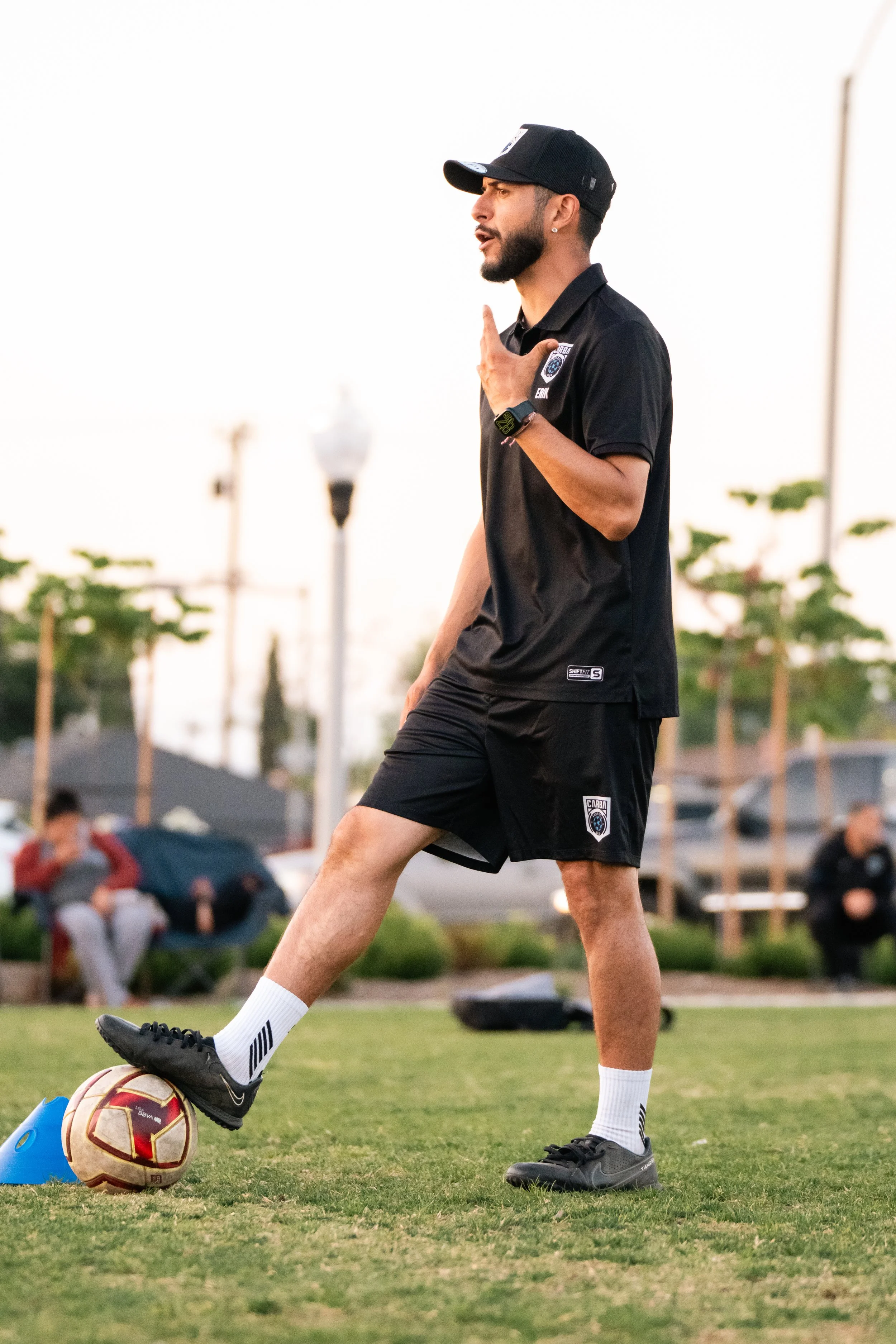 A coach wearing a Shift Sports polo.