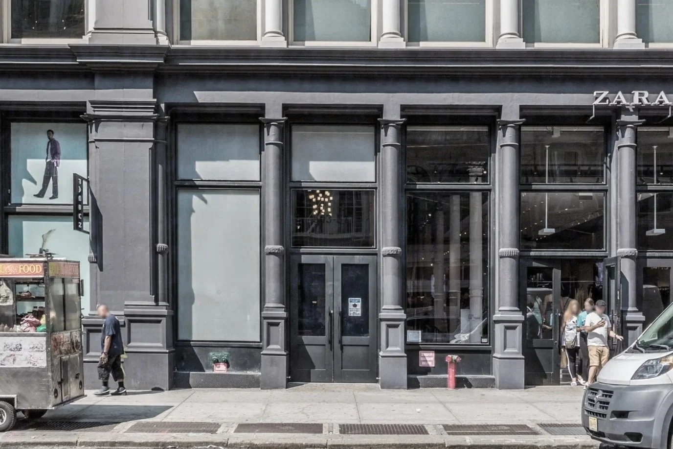 503-511 Broadway - Facade of a building with large windows, a Zara store sign, and people walking past.