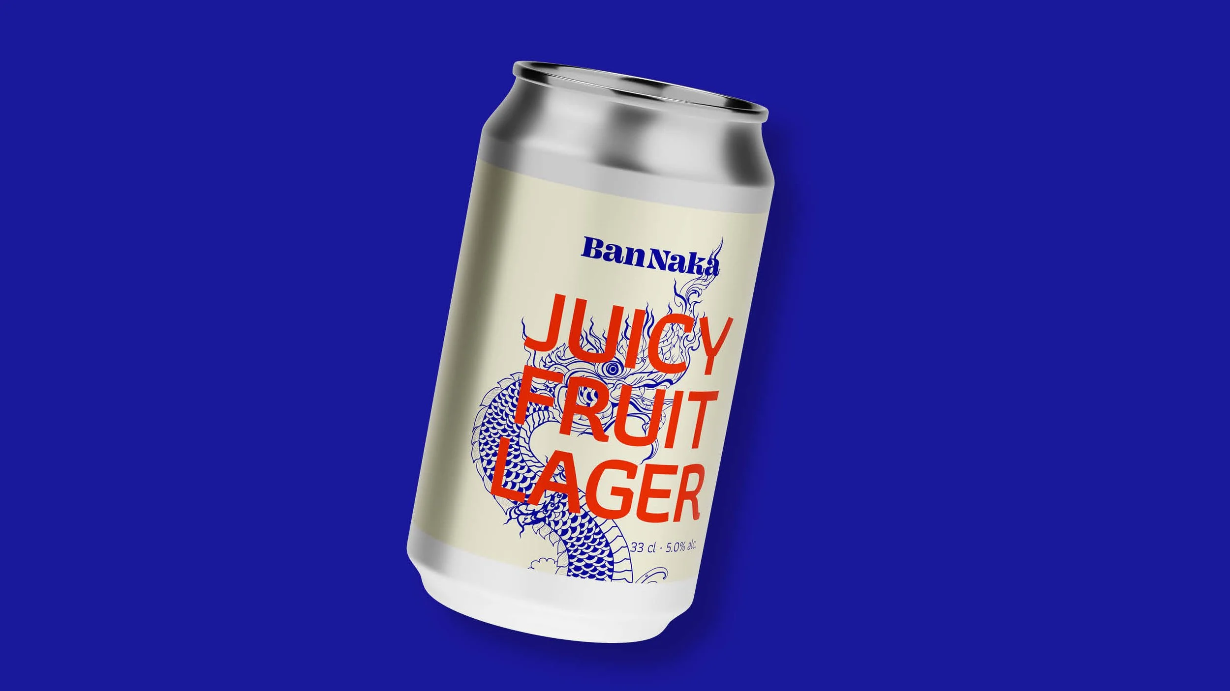 A can of Juicy Fruit Lager with a blue dragon graphic on the label, set against a solid blue background.