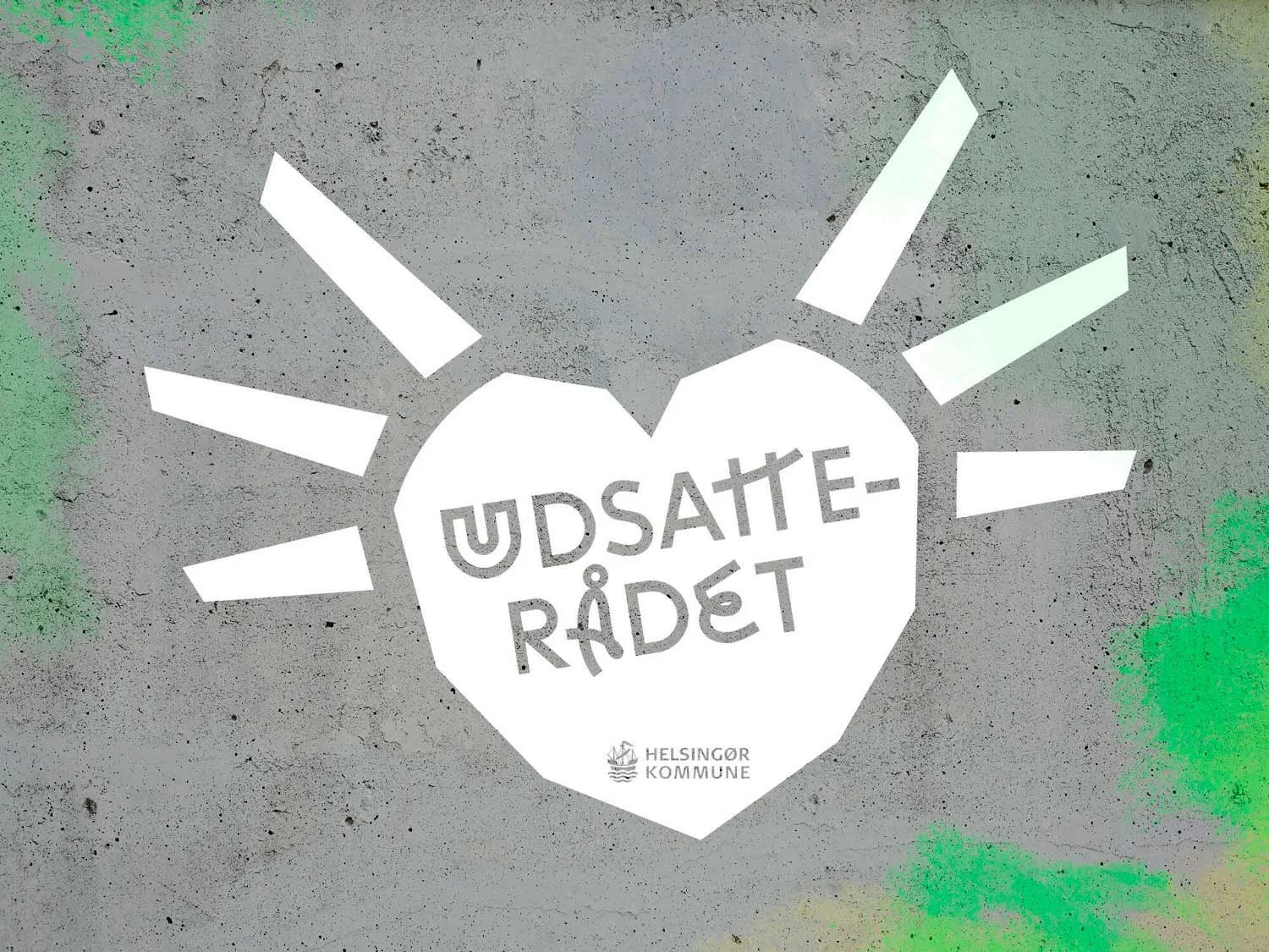 A rough cut stencil heart symbol with the text Udsatterådet inside.
