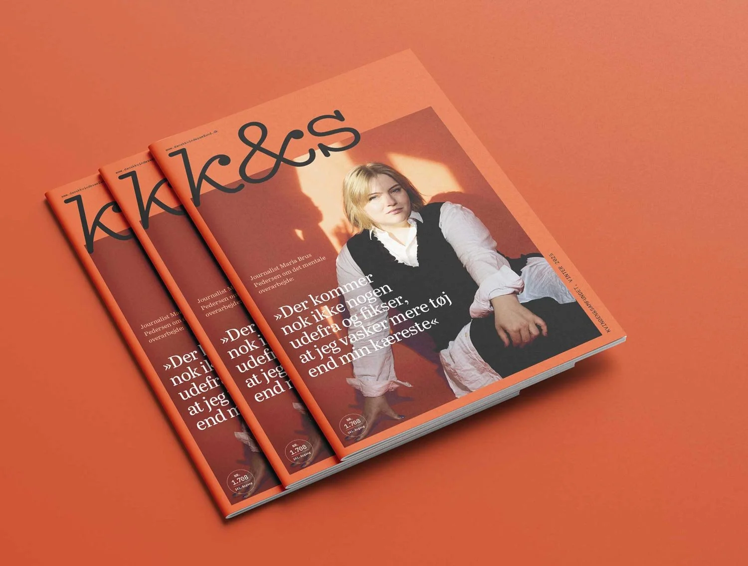 Magazine covers on an orange background. The covers features a woman in a white shirt.