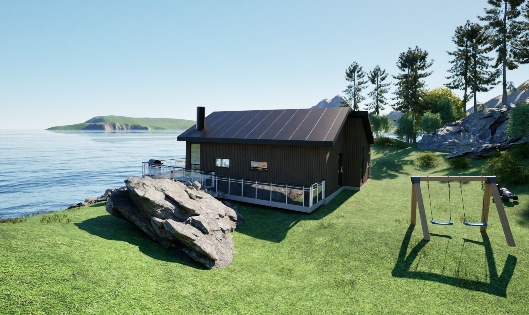 En svart fritidsbygning med tak i metall, plassert på en grønn plen nær sjøen, omgitt av trær og fjell, med en barnesvinge i forgrunnen.