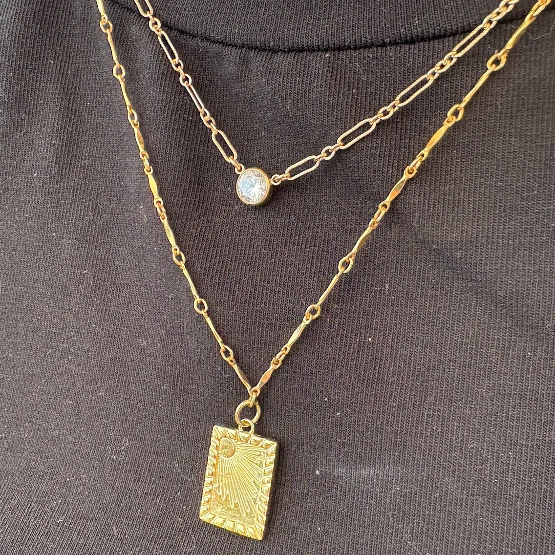 Gold Layered Necklaces, Top: textured link chain with large sparkle connector, Bottom: bamboo chain with sunburst charm