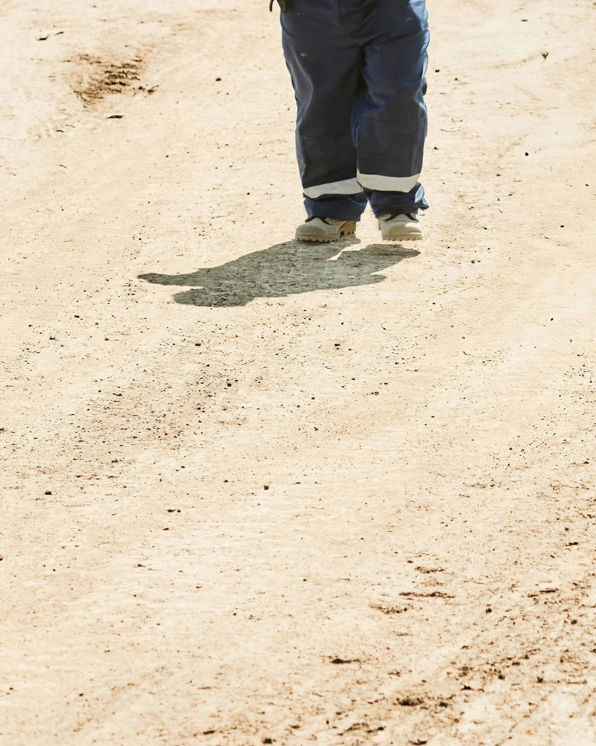 Man's legs walking on a mine site