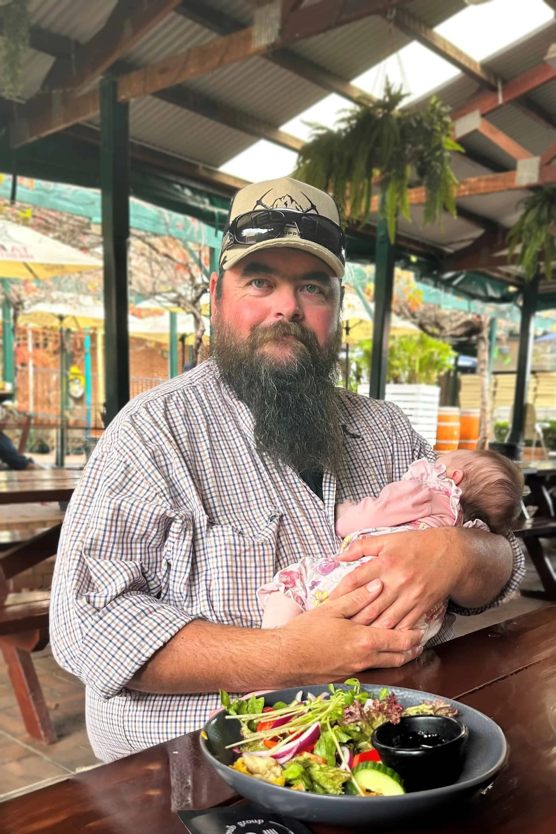 Matt at lunch holding a baby