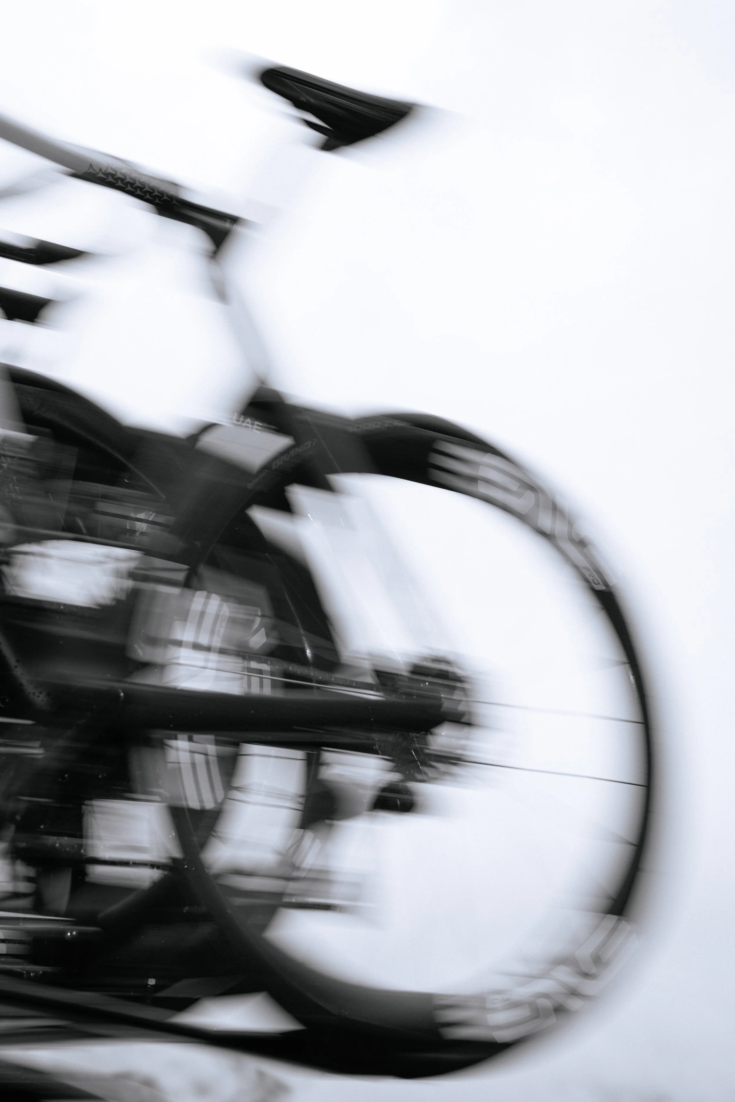 Close-up of a bicycle with a motion blur effect, focusing on the wheel and frame.