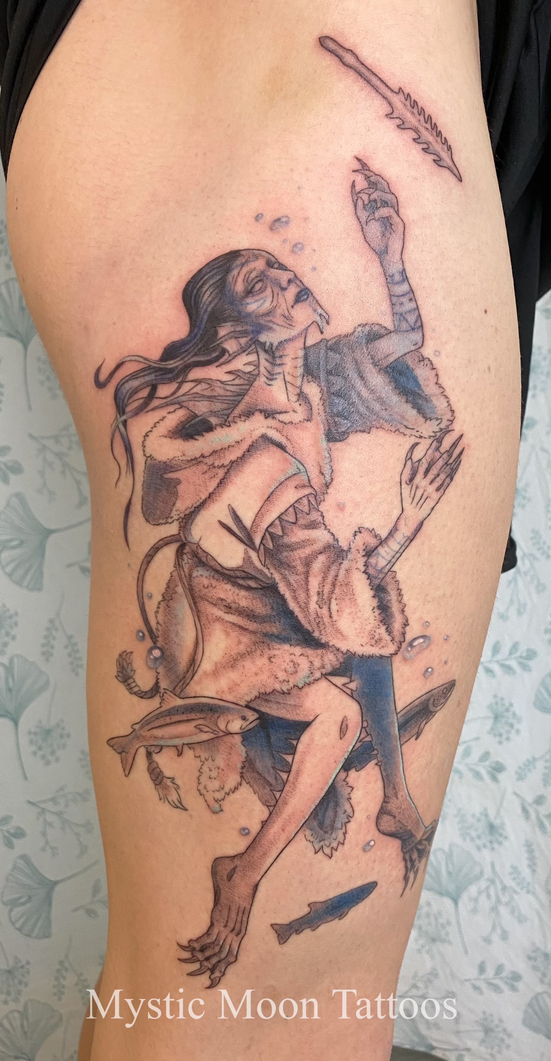 Qallupilluit reaching for child's spear.