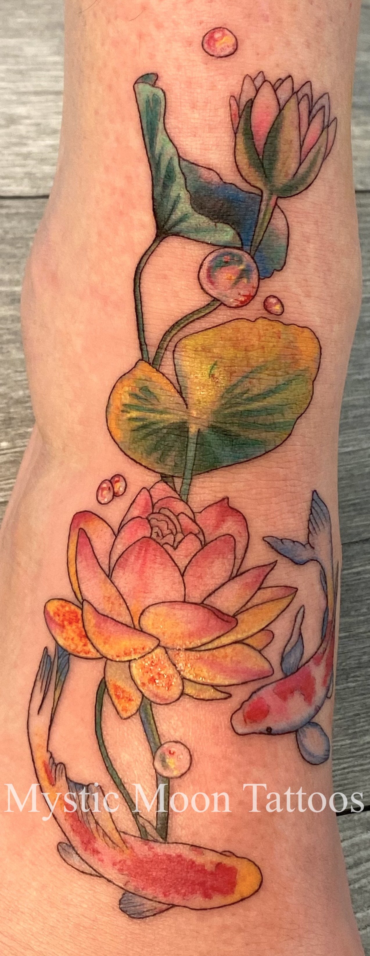 Bright vibrant colour lotus and koi fish.