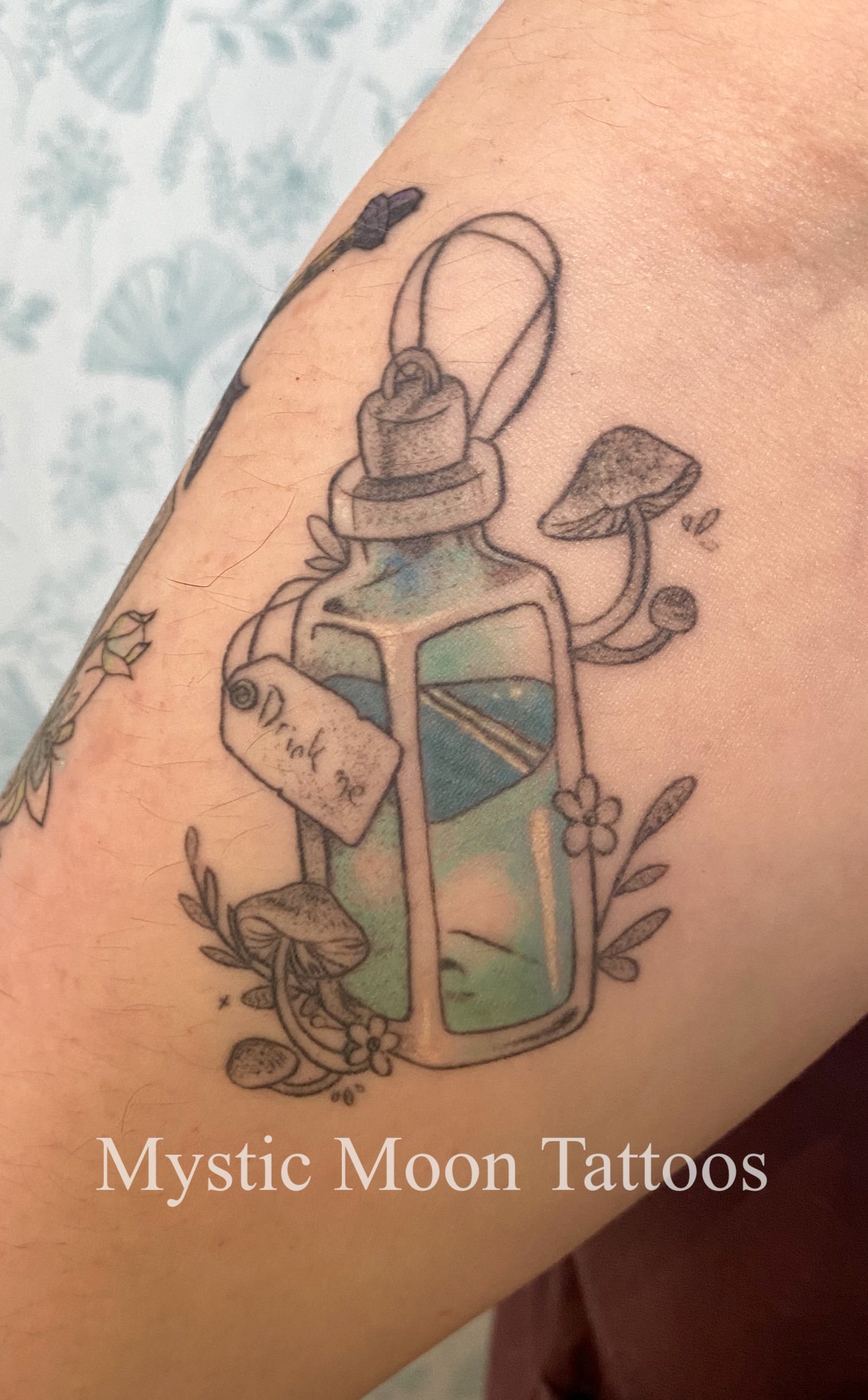Partial colour "drink me" bottle referencing Alice in Wonderland, beautifully healed!