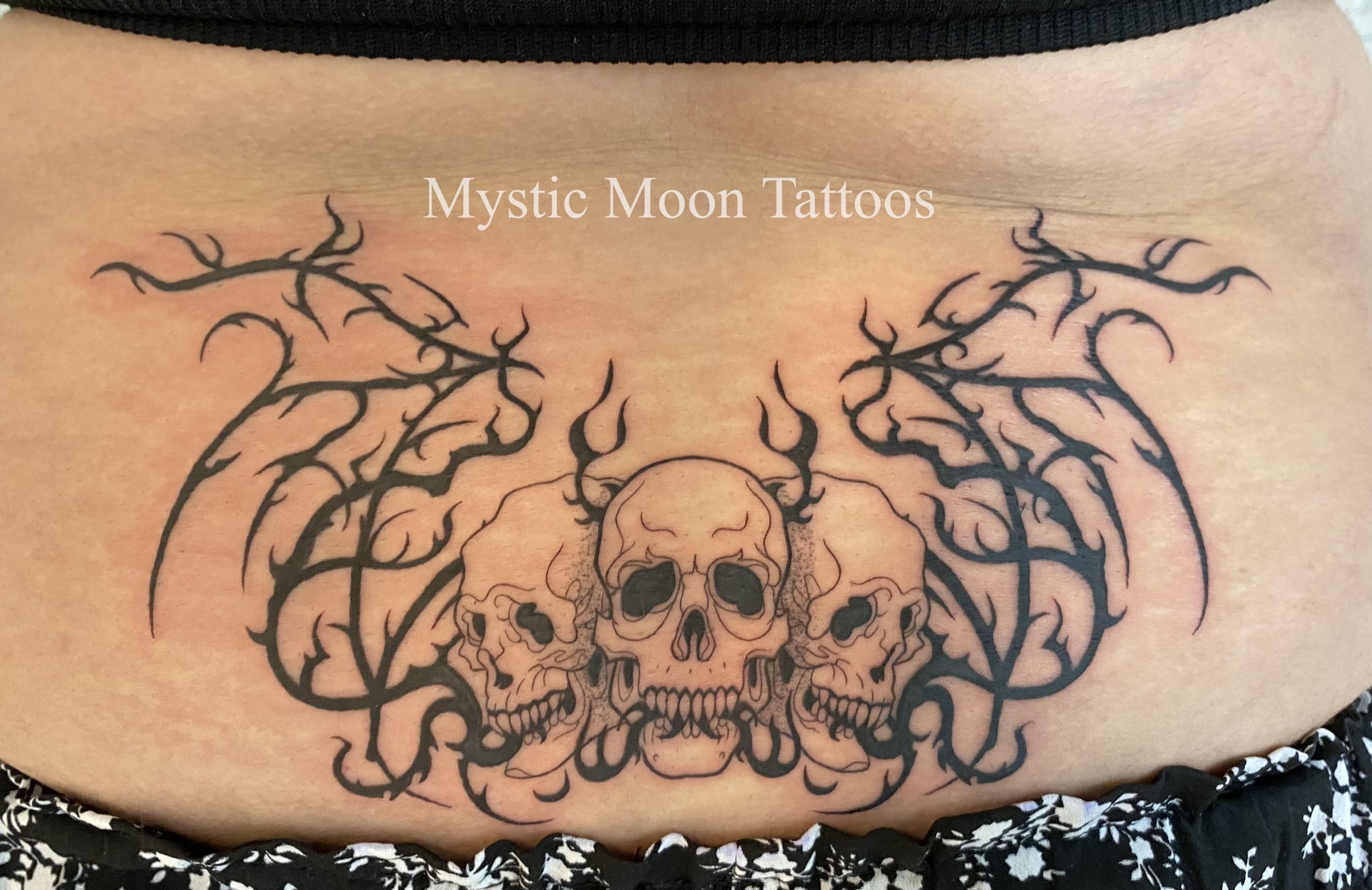 Wings and skulls cybersigilism tattoo.