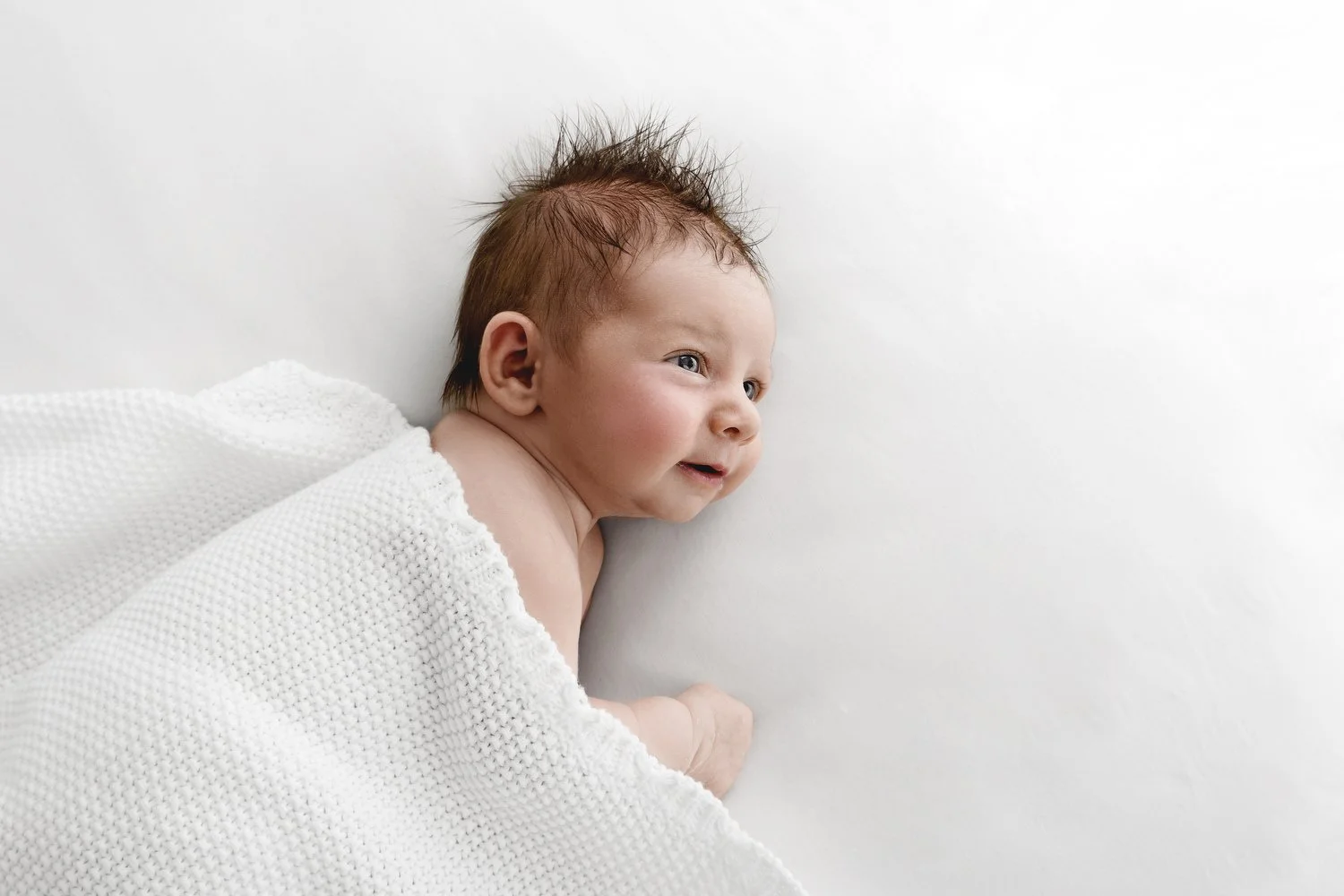 Newborn baby with masses of dark hair at Mabel and Moose studio by Ally Stuart-Ross