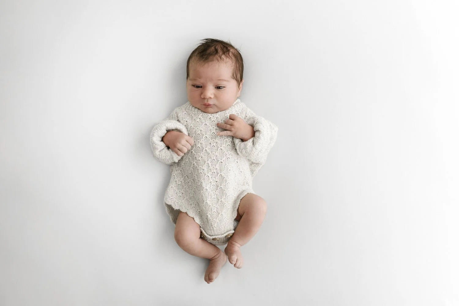 Awake newborn baby in Hank knitwear knitted romper lifestyle newborn photography