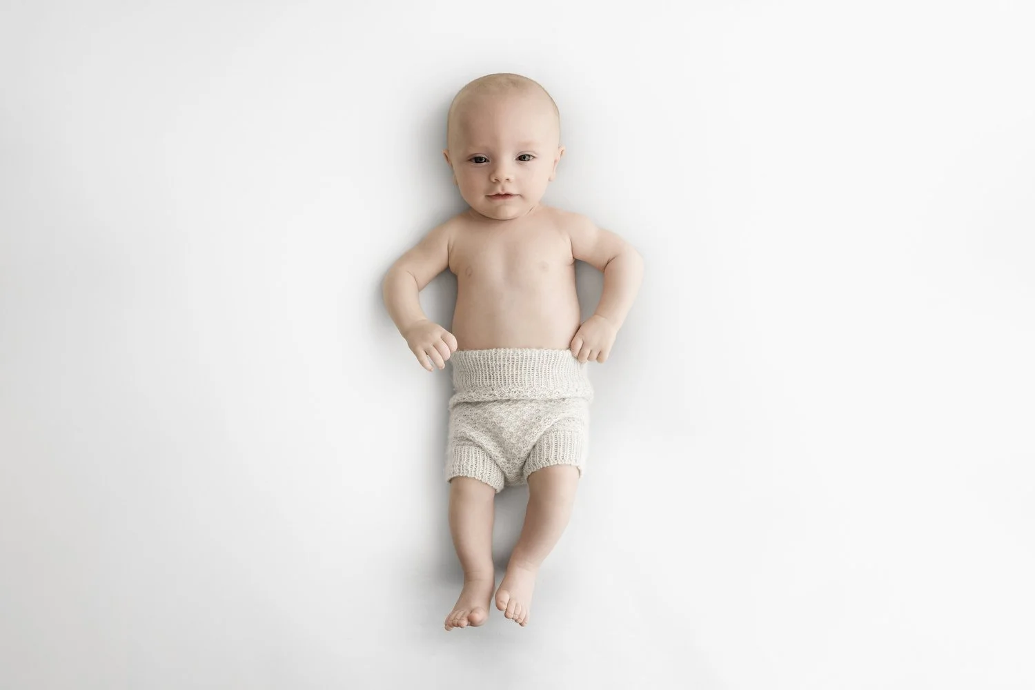 Awake 3 month old baby on beanbag at Mabel and Moose studio by Ally Stuart-Ross