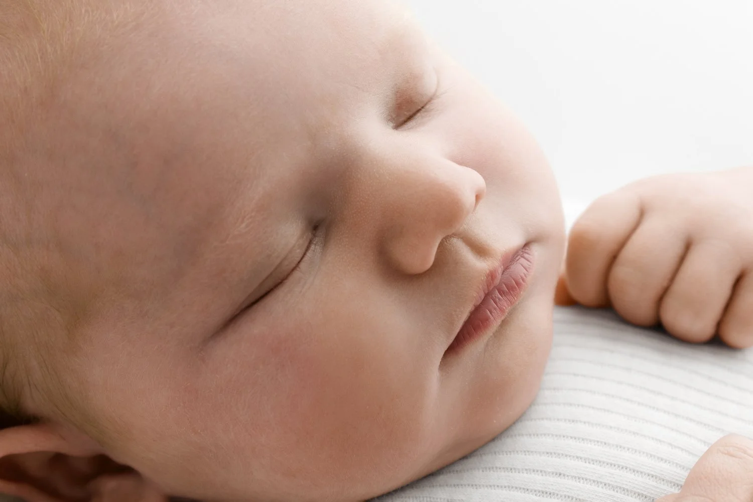 Newborn baby with natural warm skin tones photographed by Ally Stuart-Ross Mabel and Moose