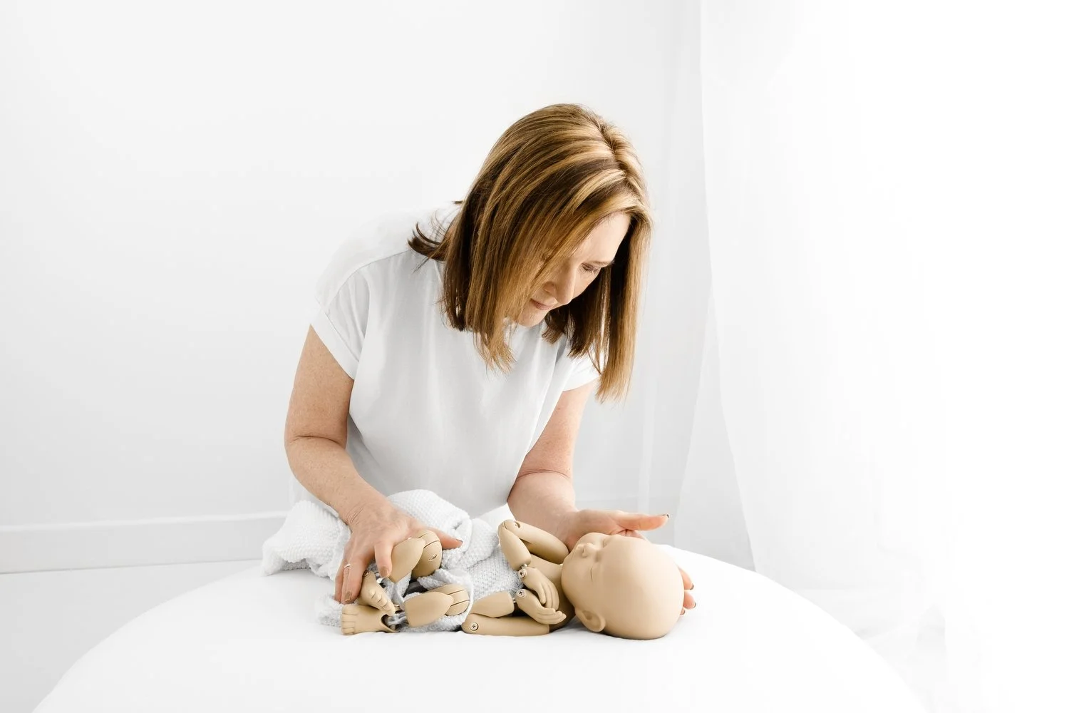 photographer demonstrating wrapping standinbaby