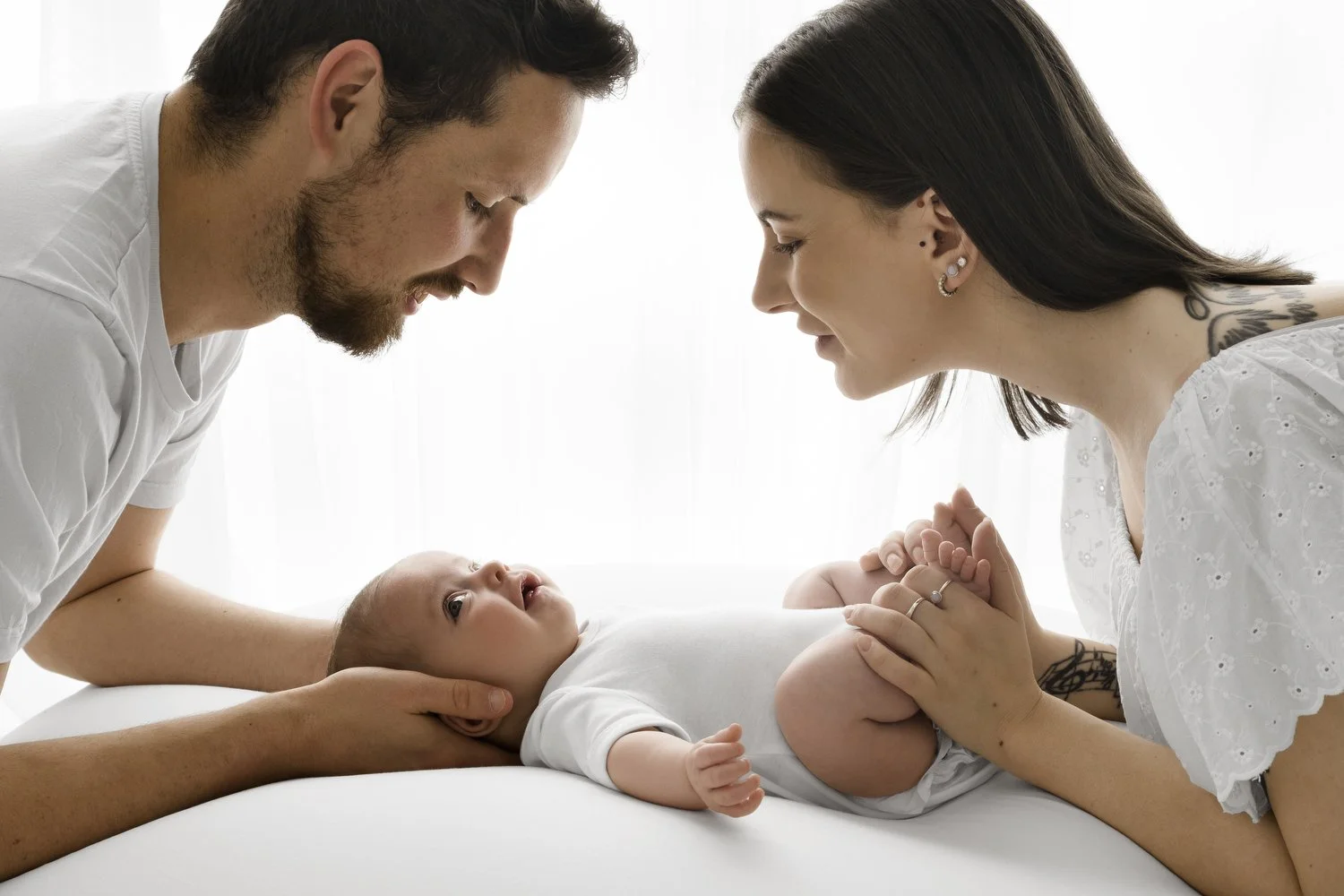 Parents with 4 month old baby on beanbag at Mabel and Moose studio by Ally Stuart-Ross