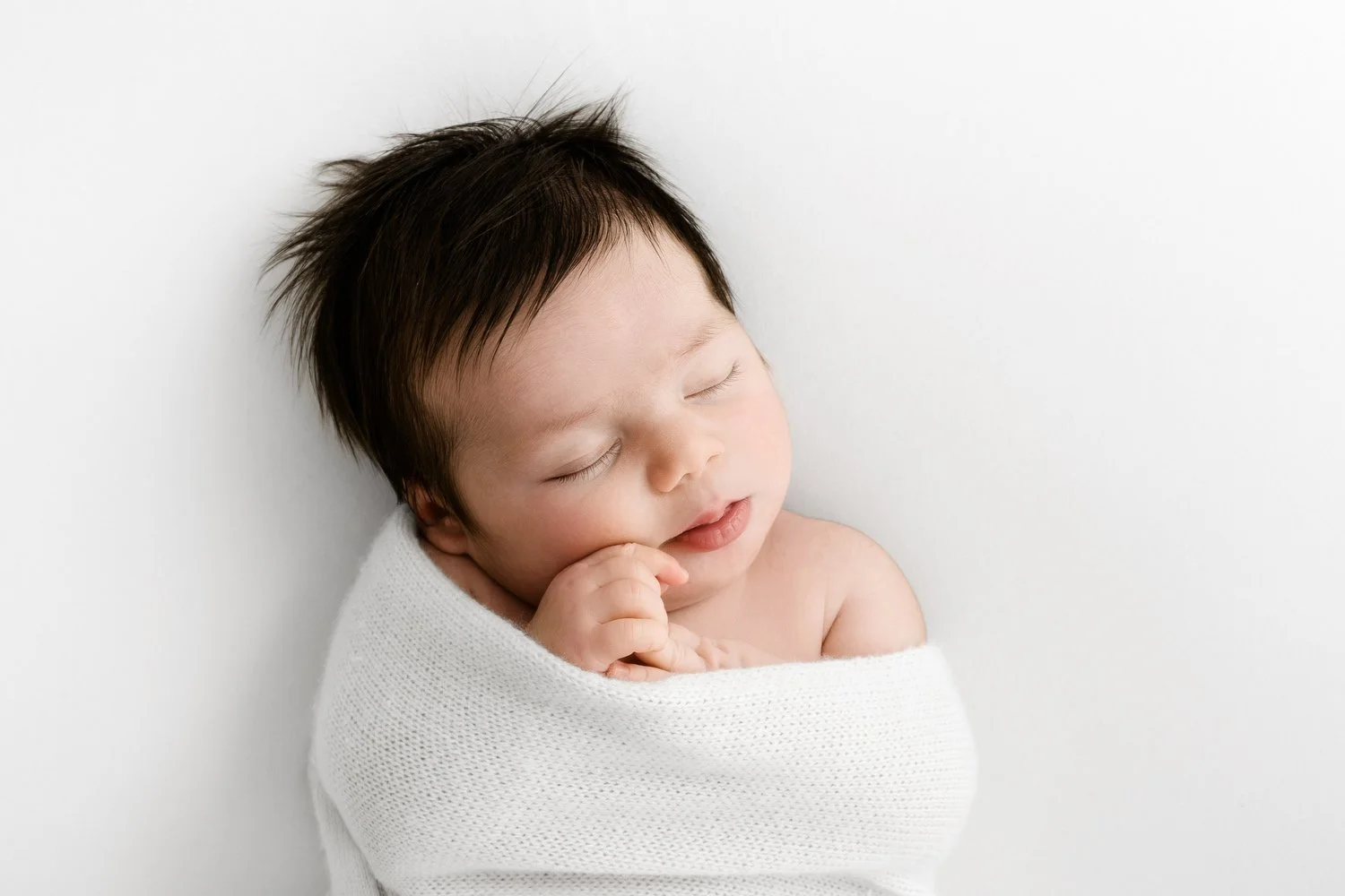 Sleeping newborn baby on white backdrop minimalist lifestyle newborn photography