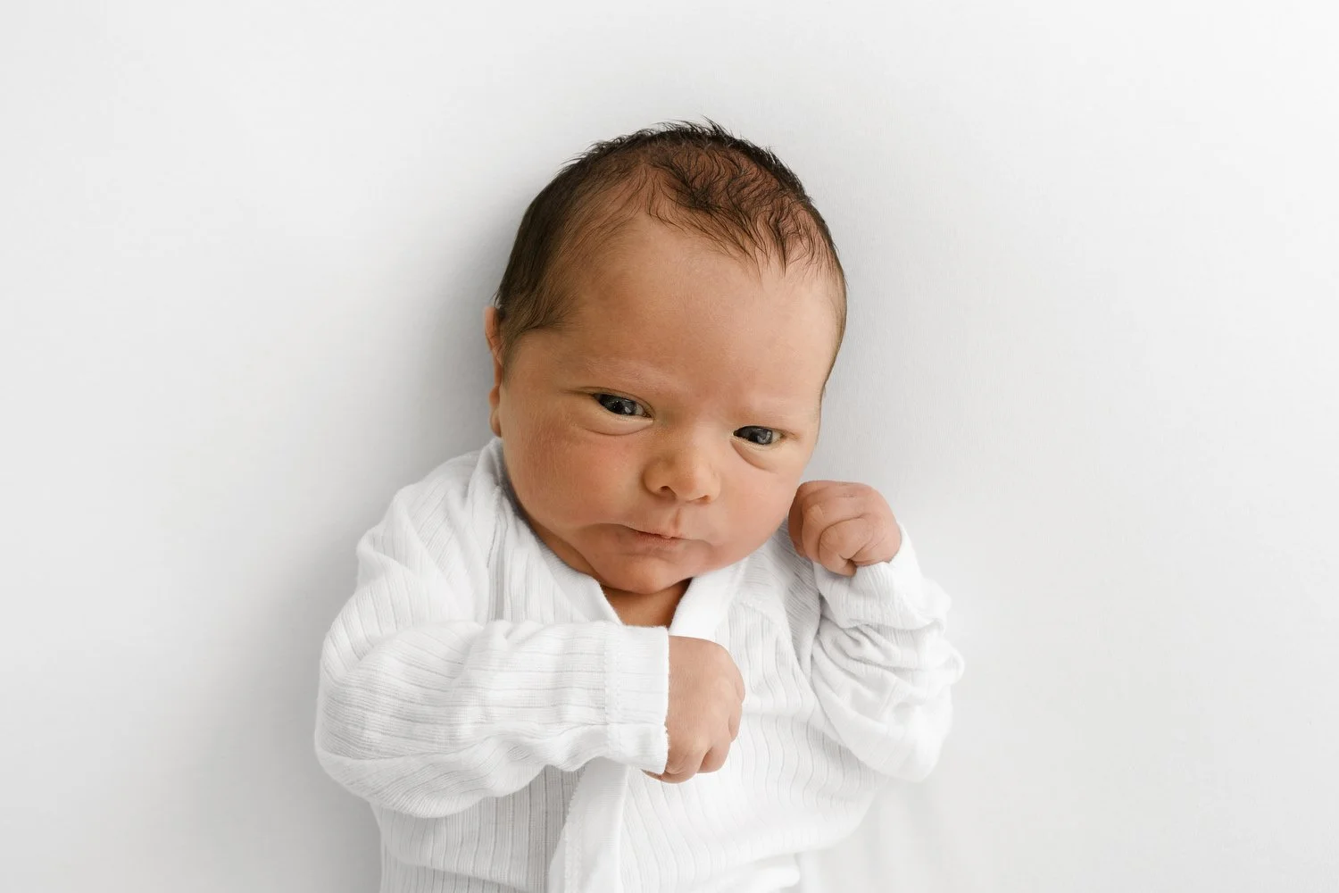 4 day old newborn baby with eyes open during lifestyle newborn photography session