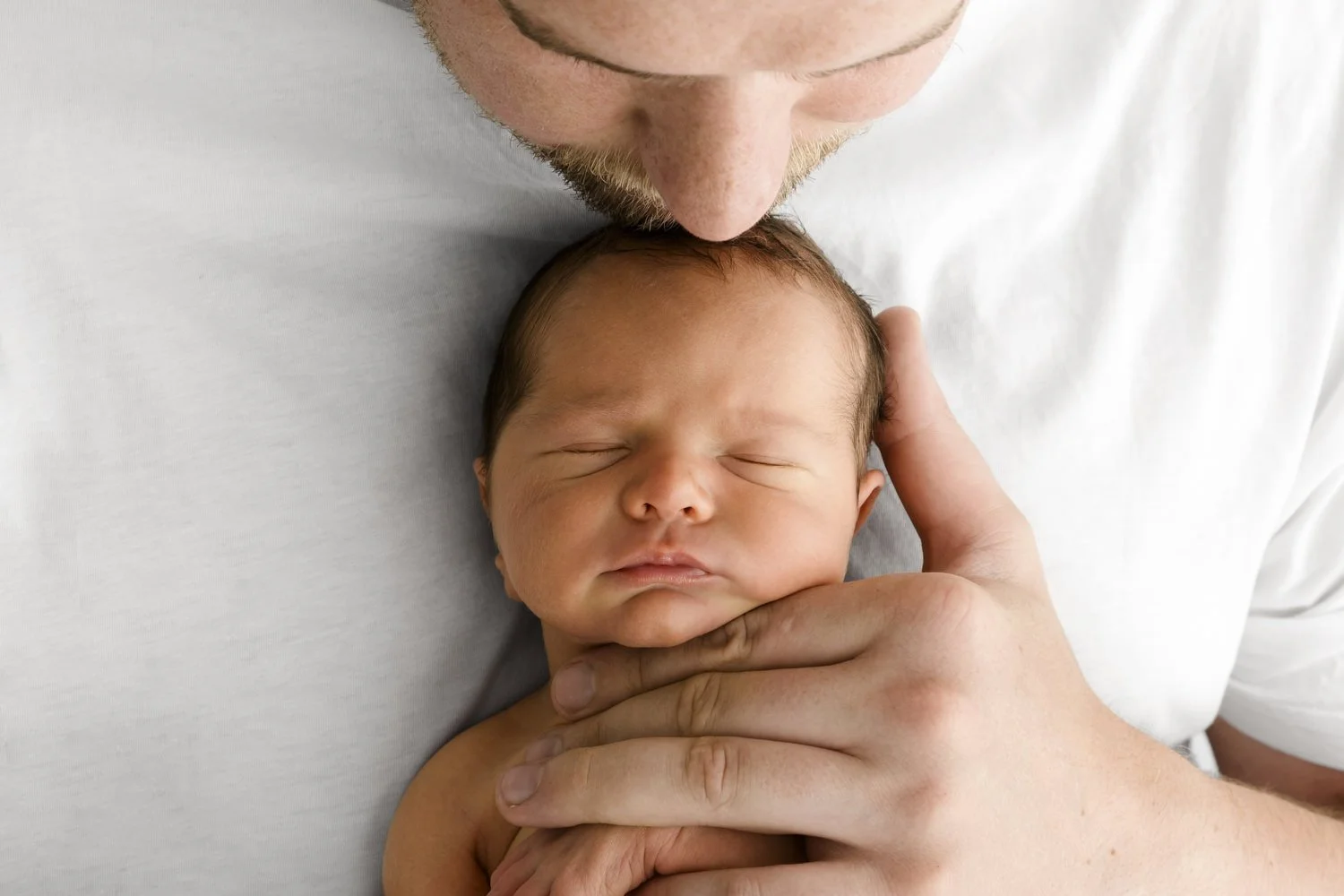 Dad with newborn baby at lifestyle newborn photography session