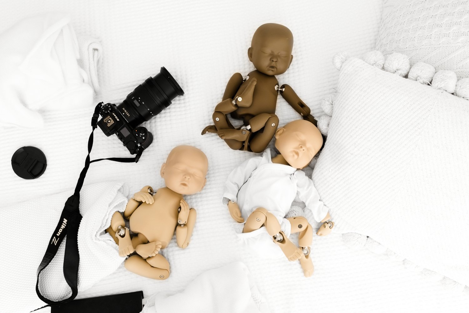 stand in baby posing dolls at newborn workshop with camera