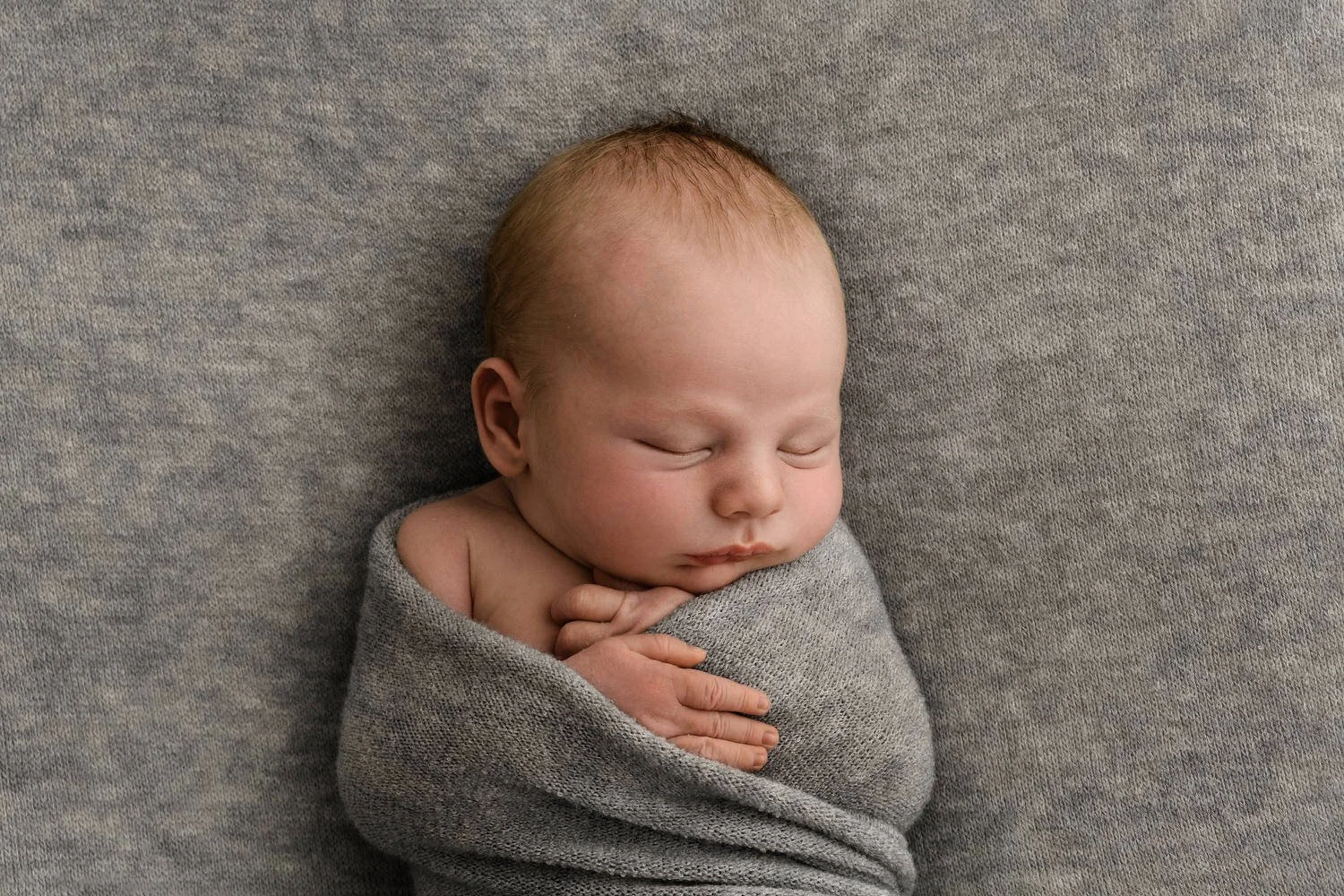 Sleeping newborn baby on grey backdrop minimalist lifestyle newborn photography
