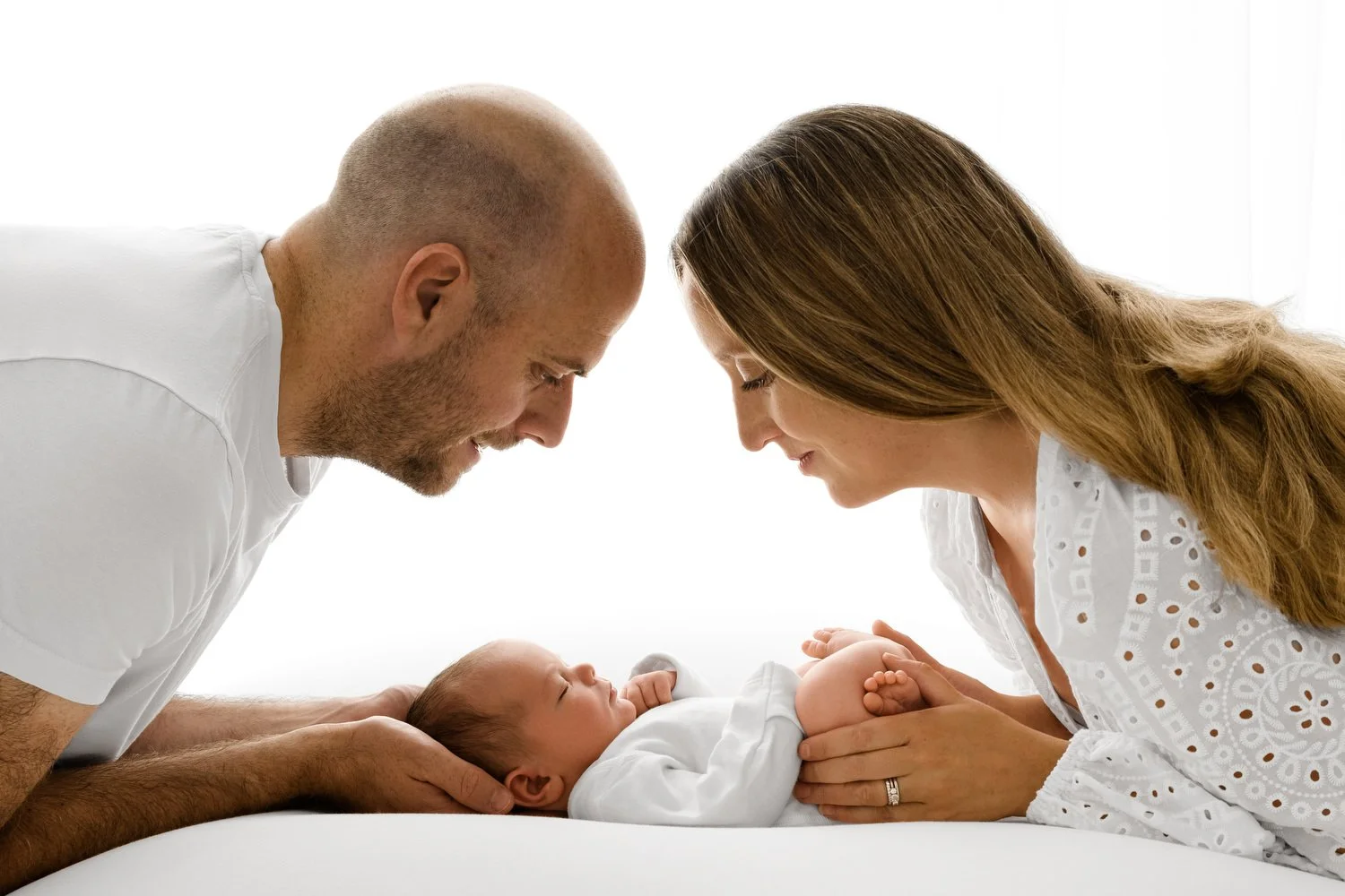 Parents holding newborn baby — natural newborn photography Scotland