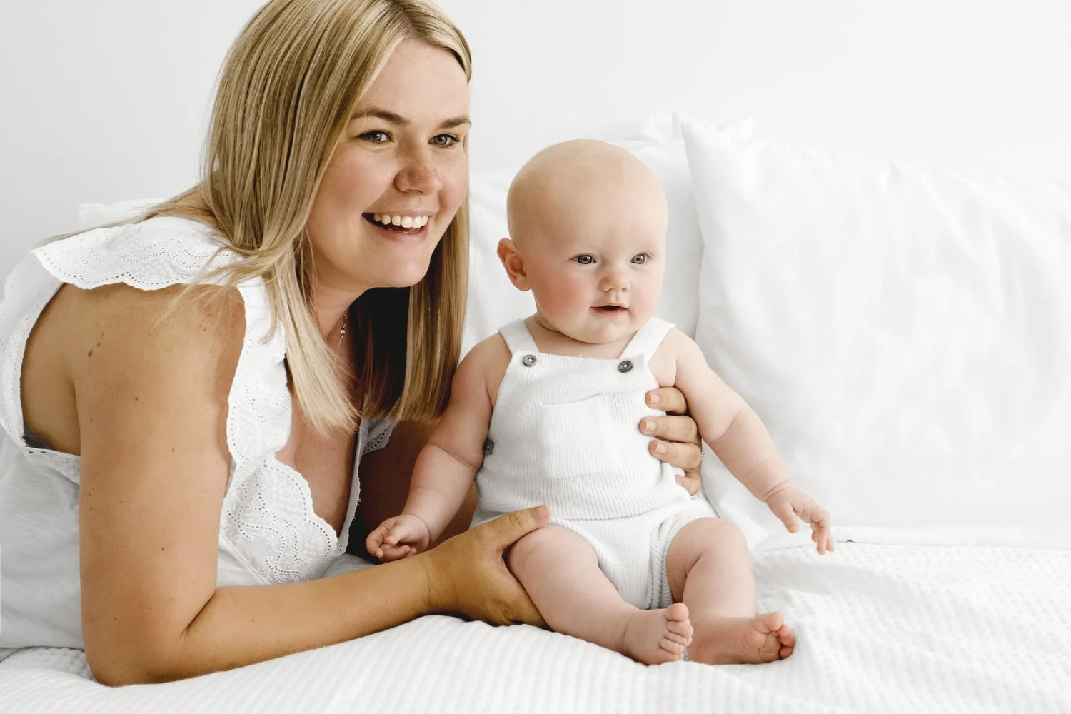 Mum holding 5 month old baby sitting at Mabel and Moose studio by Ally Stuart-Ross