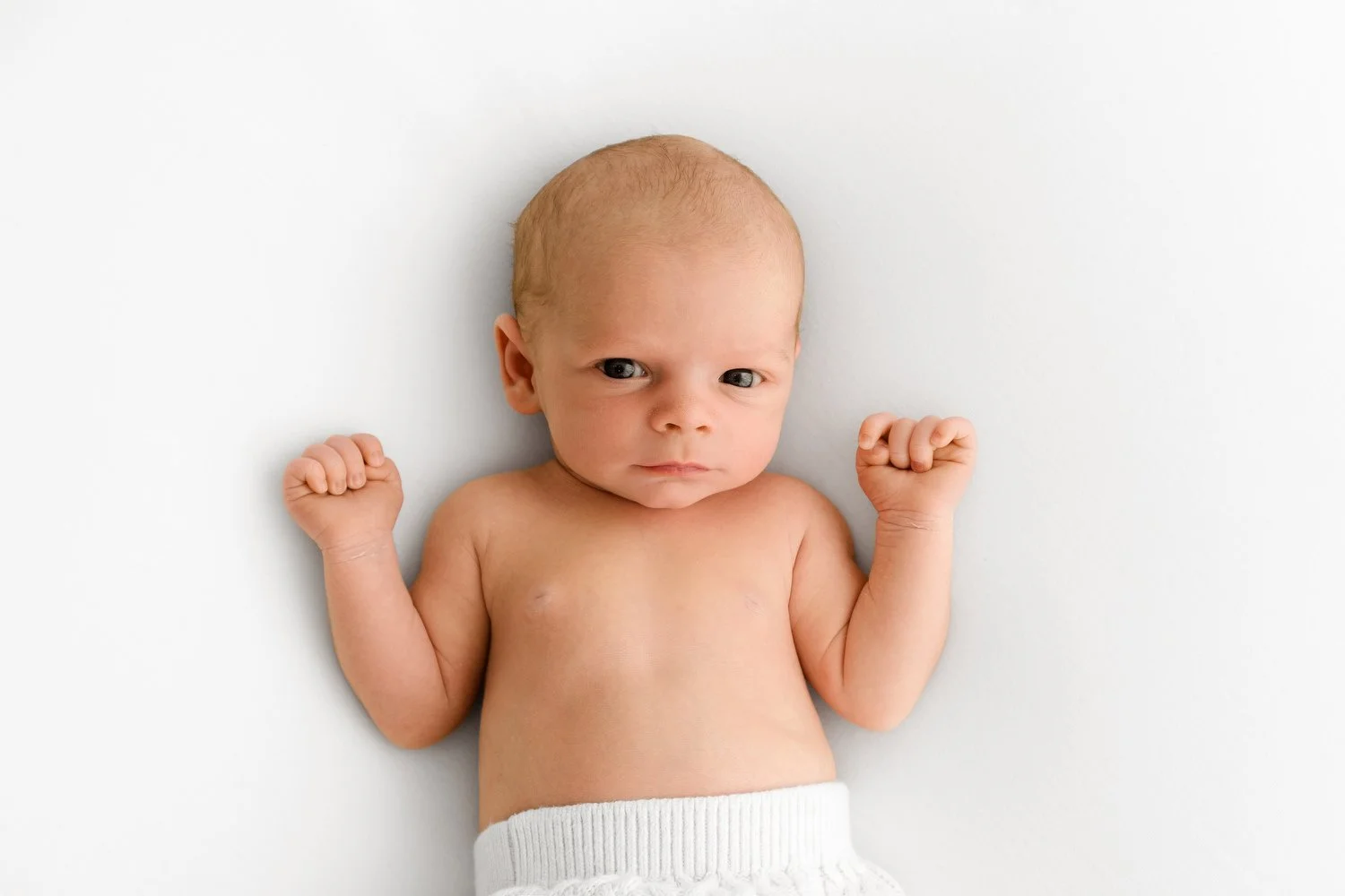 Newborn baby photographed at F6.4 with soft, dreamy background