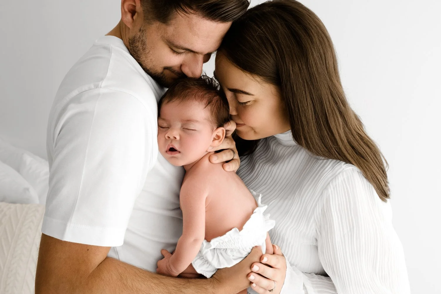 Parents with settled newborn baby at Mabel and Moose photography studio by Ally Stuart-Ross